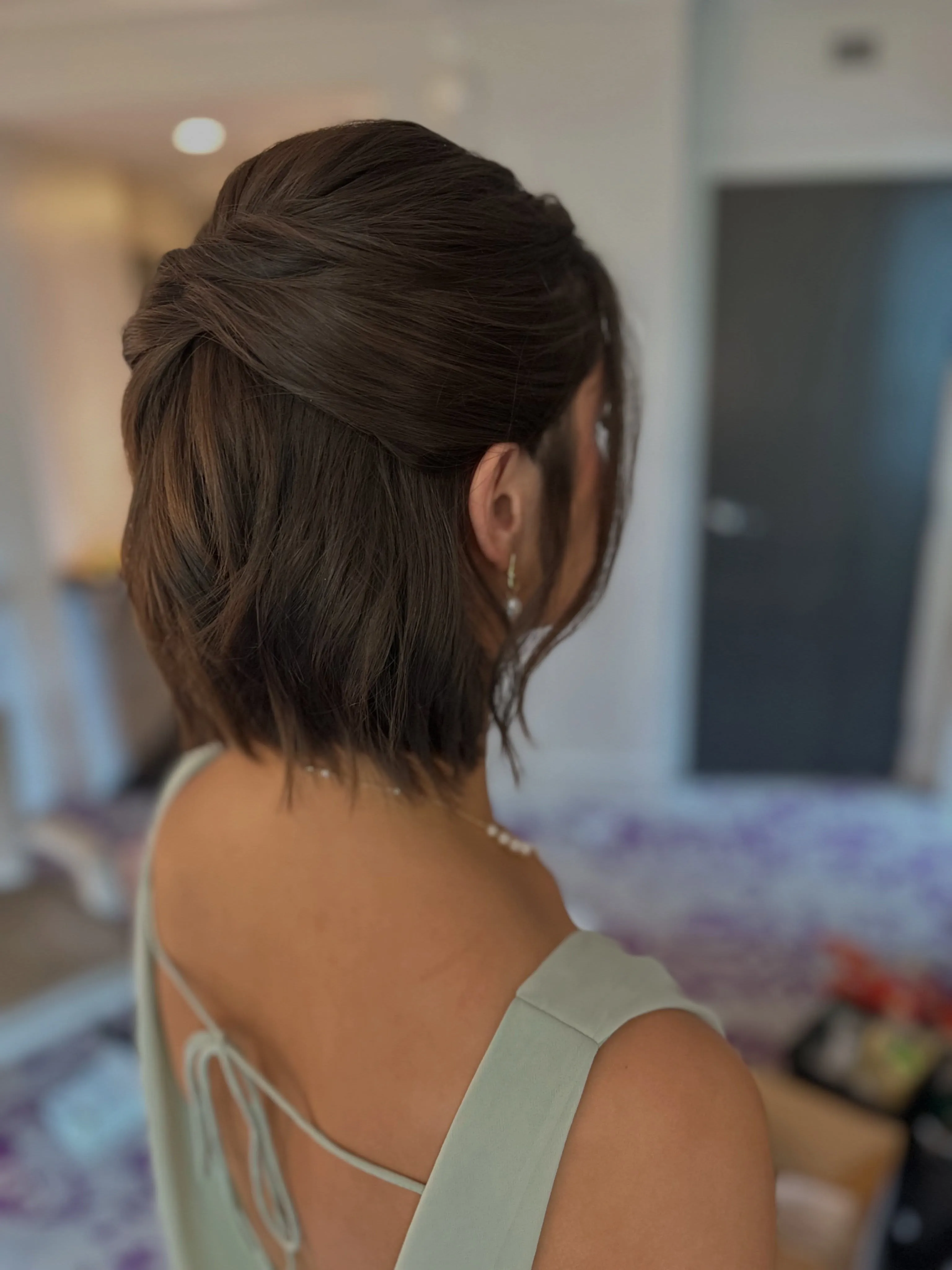 Short bob with a smooth twisted half-up style