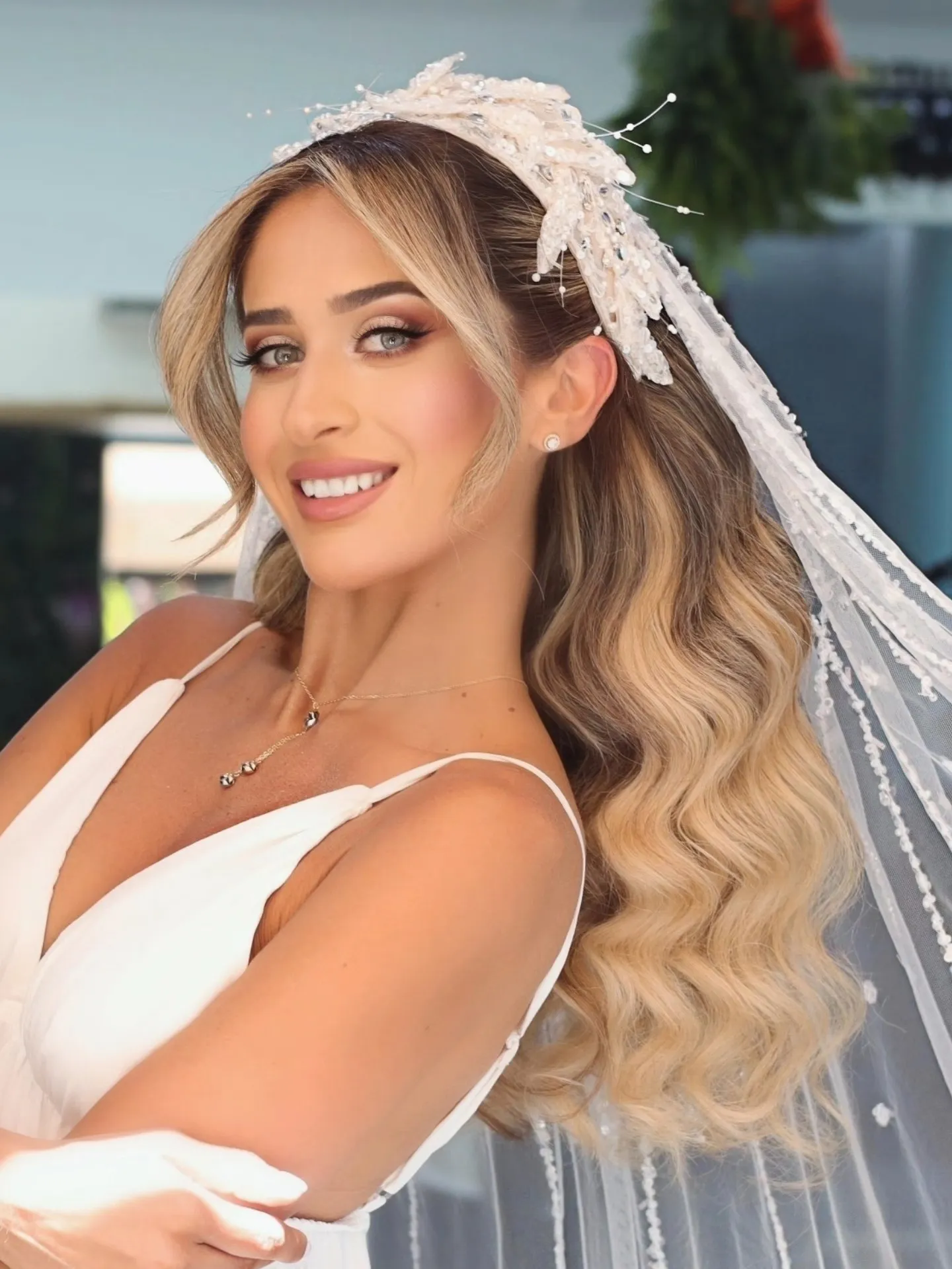 Long blonde wedding waves with a crystal crown and veil