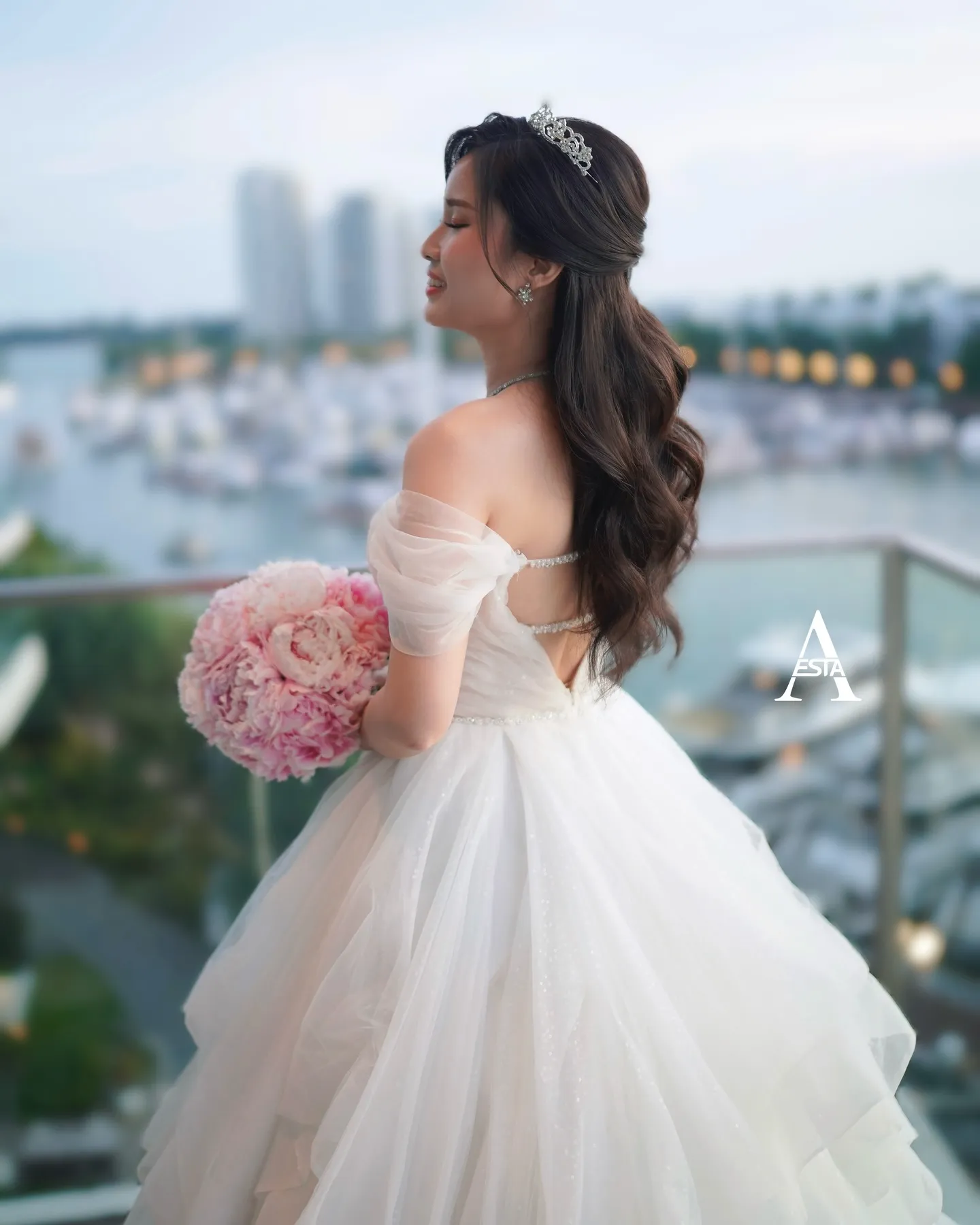 Long brunette half-up waves with a petite silver crown