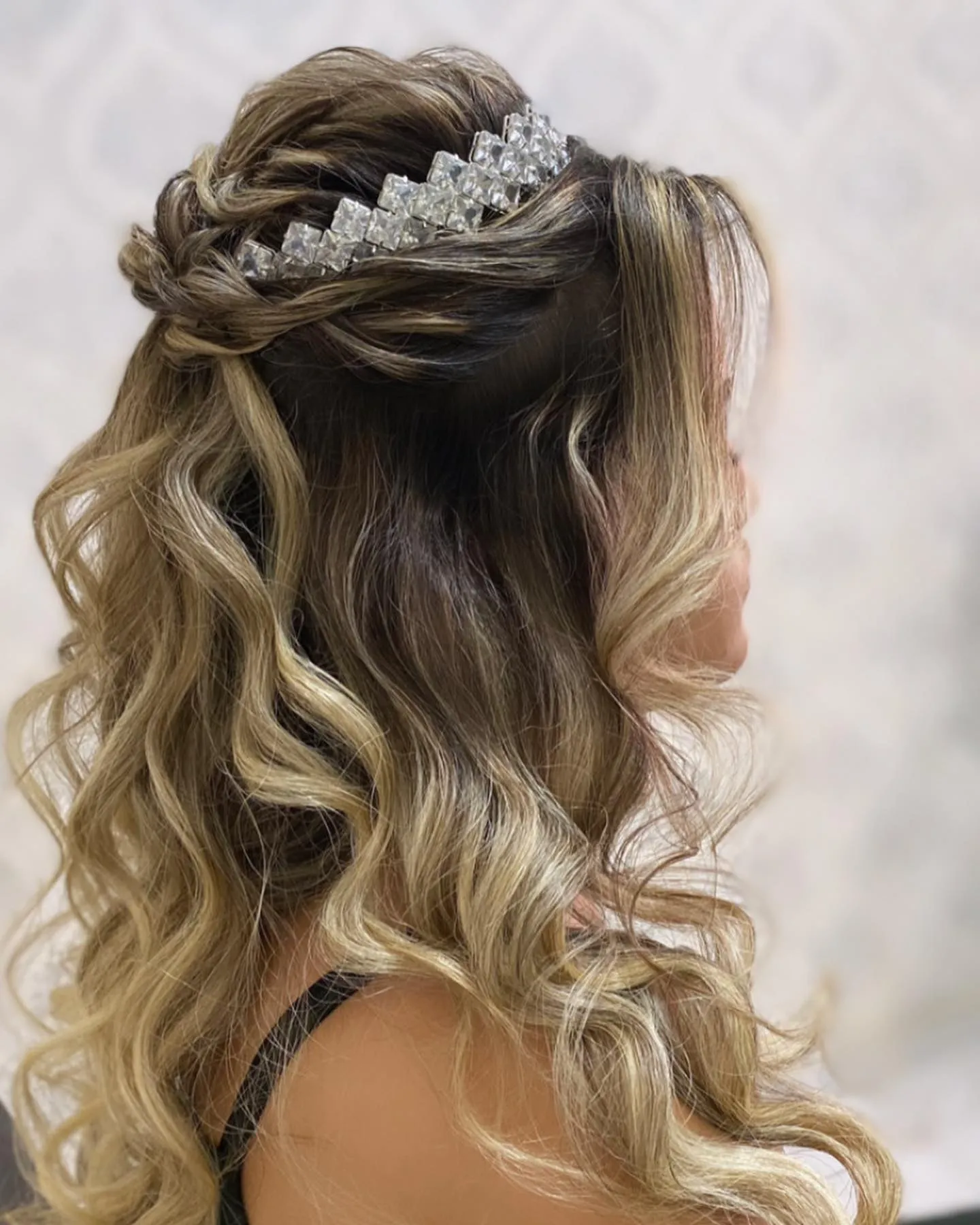 Voluminous blonde half-up waves with a crystal tiara