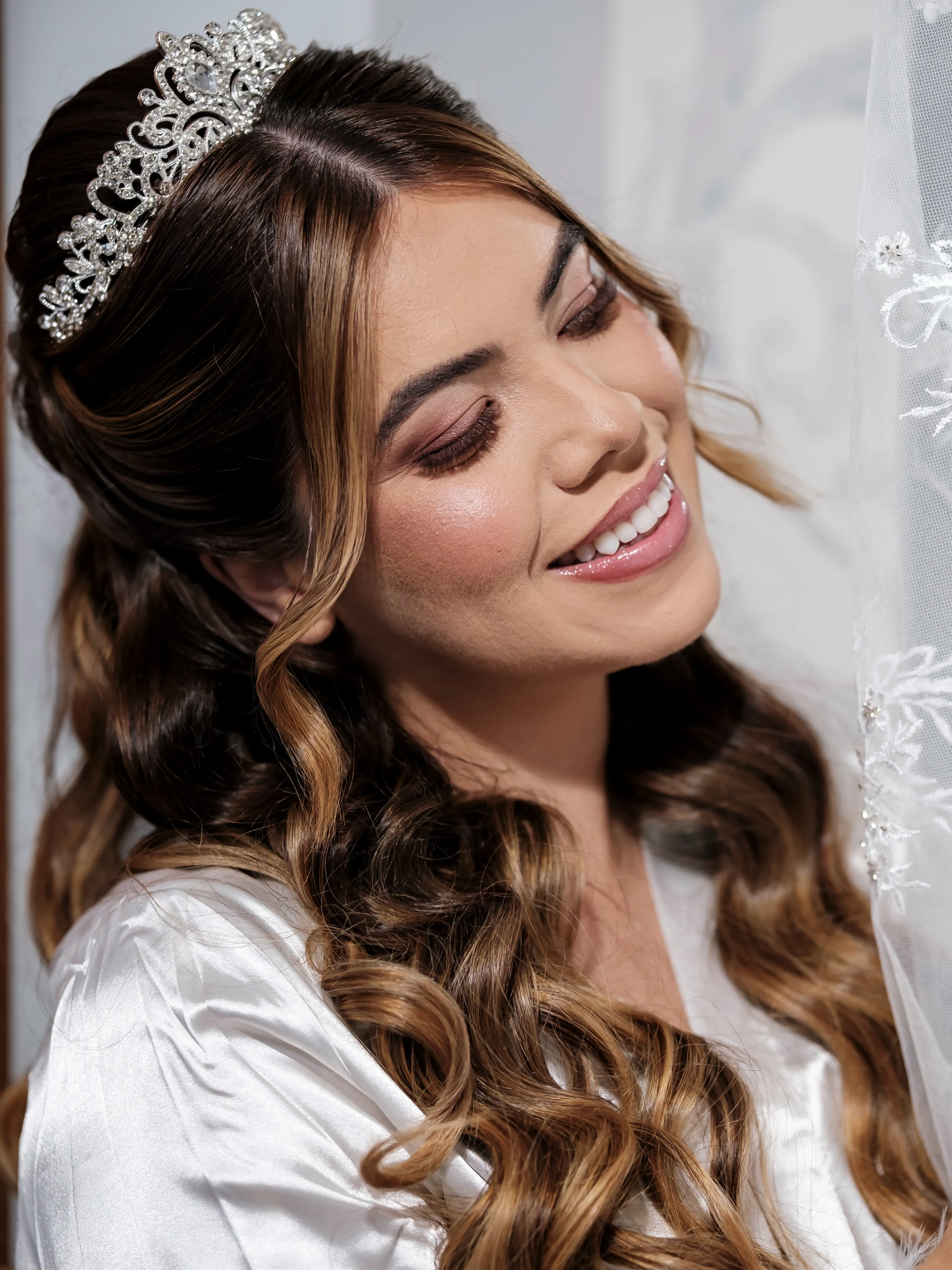 Long brunette half-up curls with a silver tiara