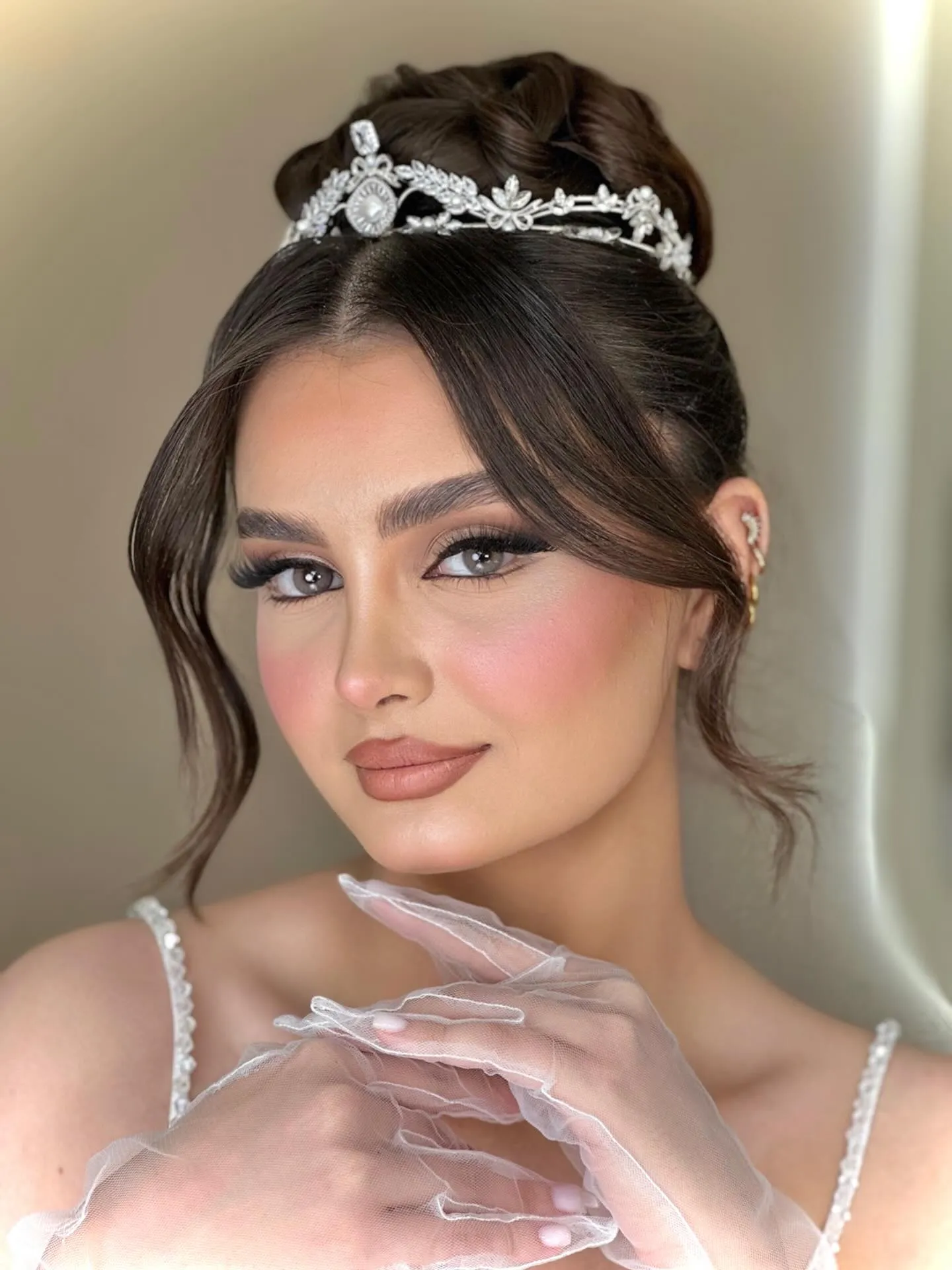 Low textured bun with a petite silver tiara