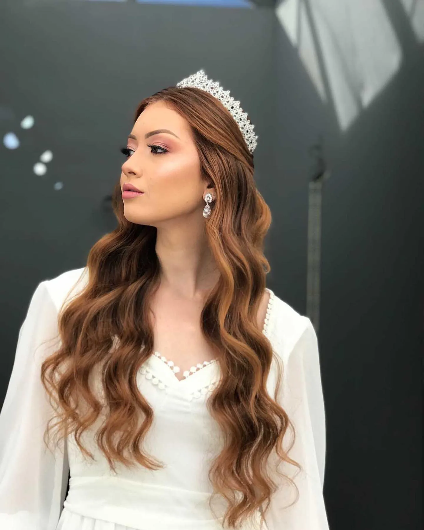 Long loose brunette waves with a classic silver tiara