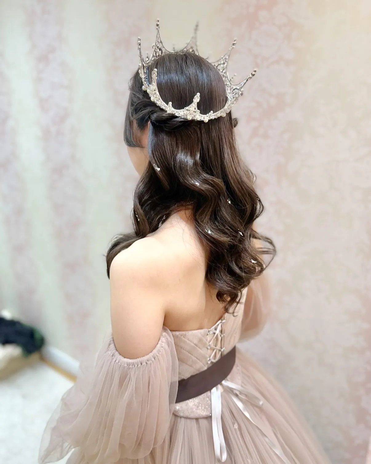 Half-up brunette waves with a delicate silver crown