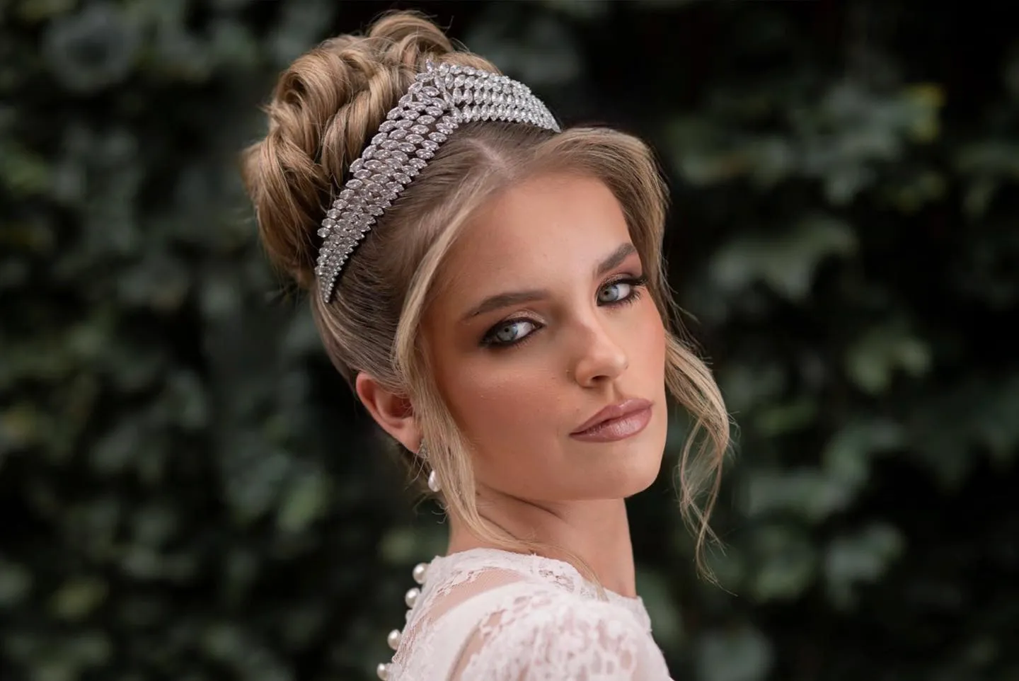 High braided bun with a sparkling bridal crown