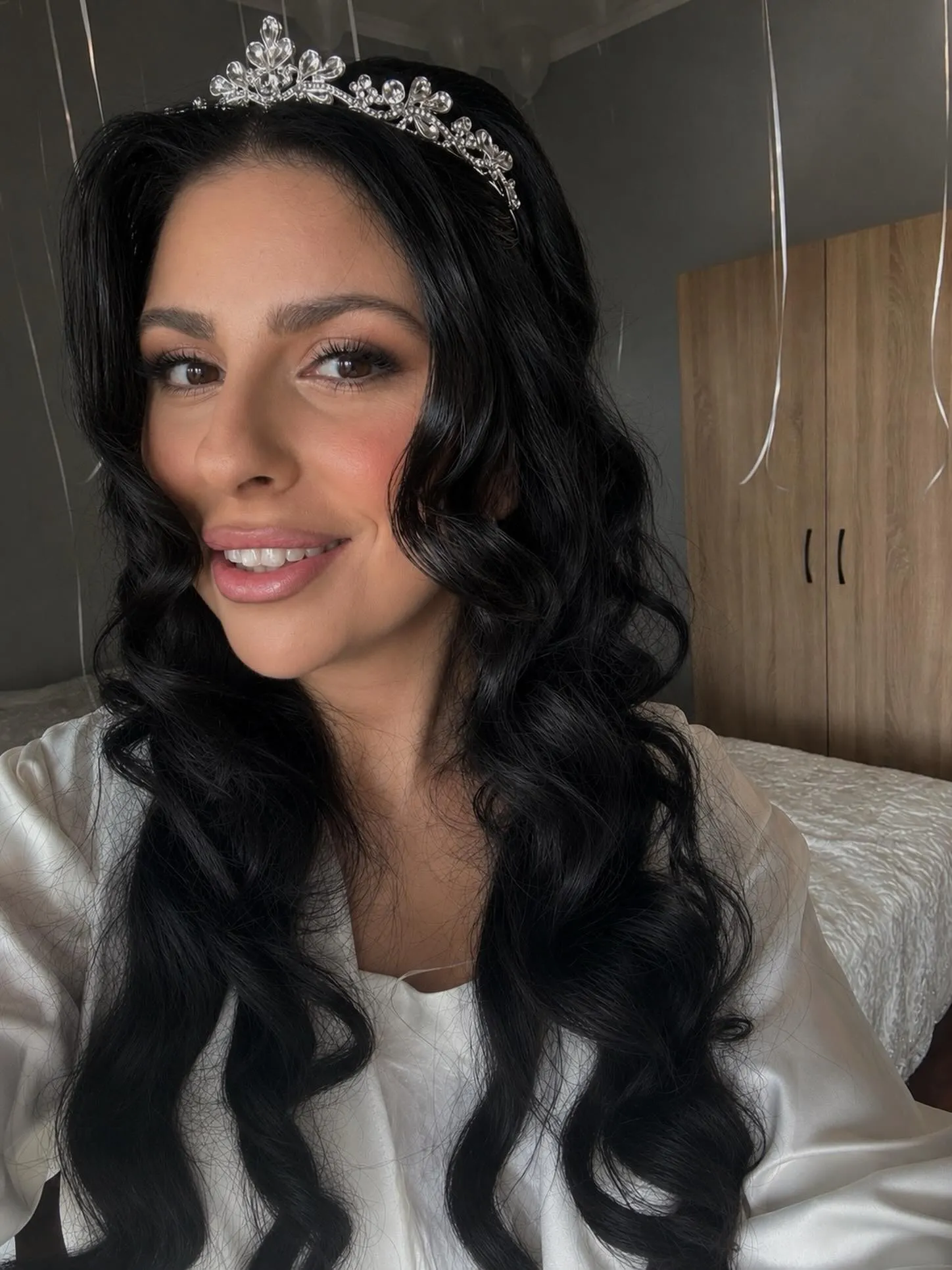 Long black waves with a small silver tiara