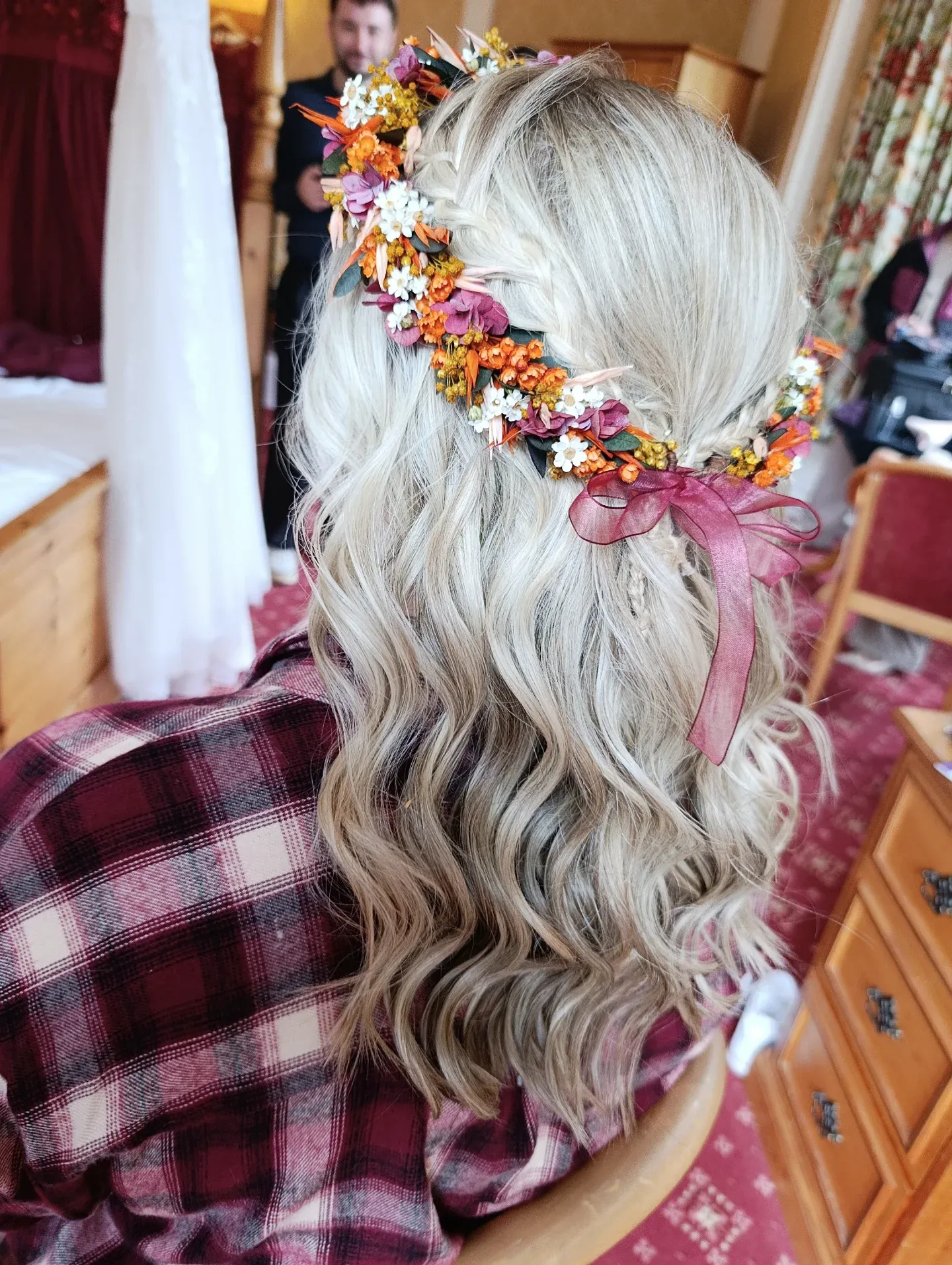 Long blonde half-up waves with a colourful flower crown and ribbon