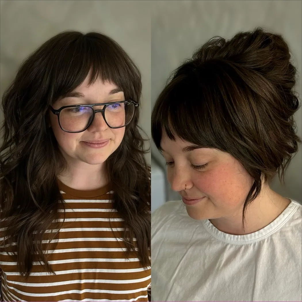 Textured dark updo with a rounded full fringe and loose side pieces