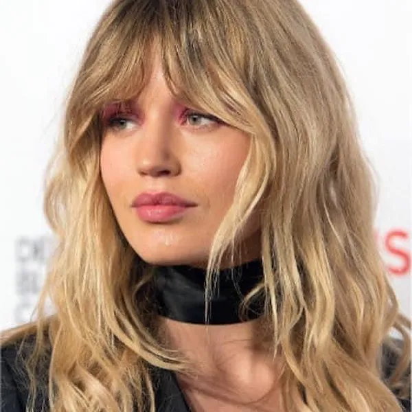 Long blonde layered waves with a soft curtain fringe