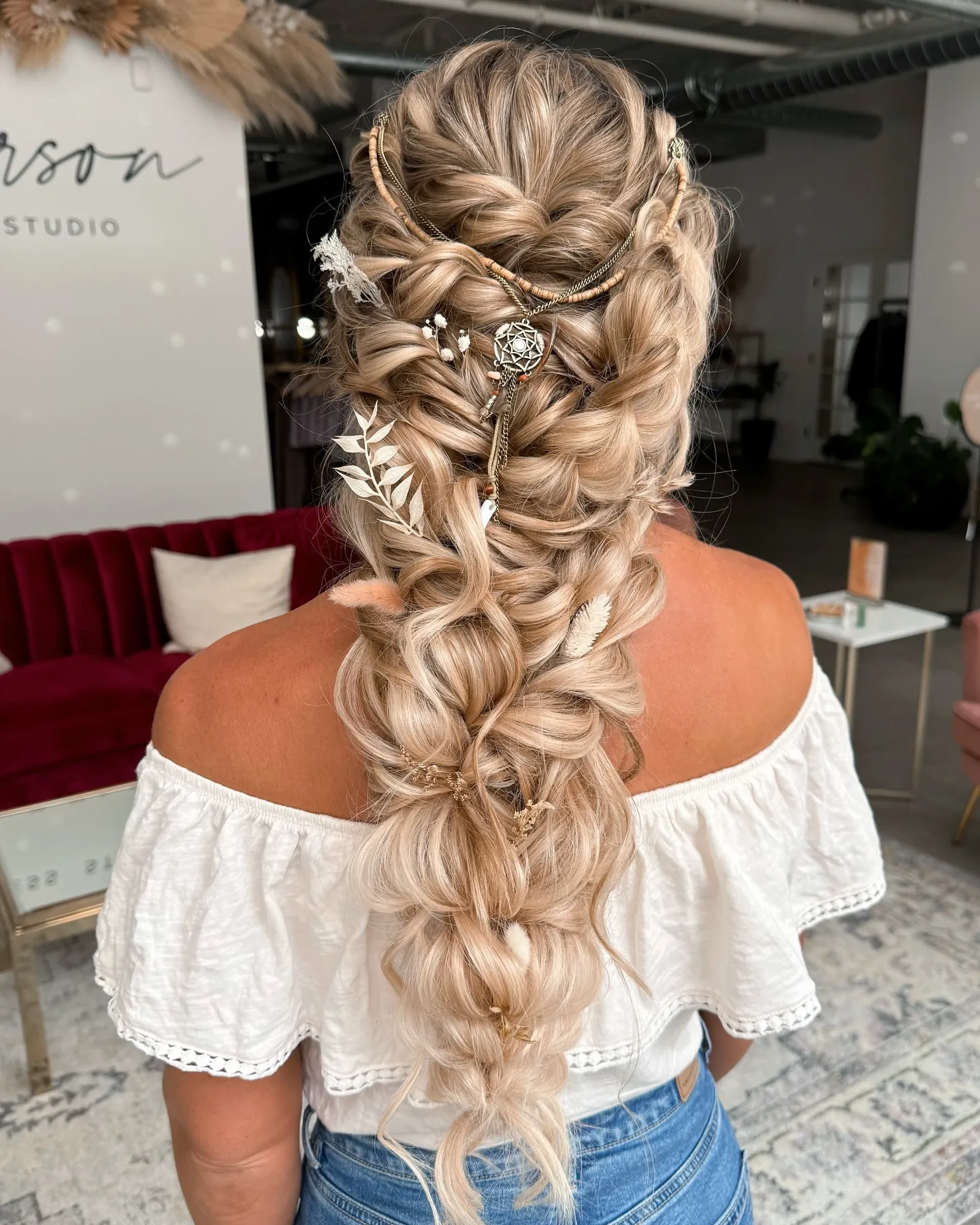 Long bohemian braided ponytail with chains, pearls, and hanging charms