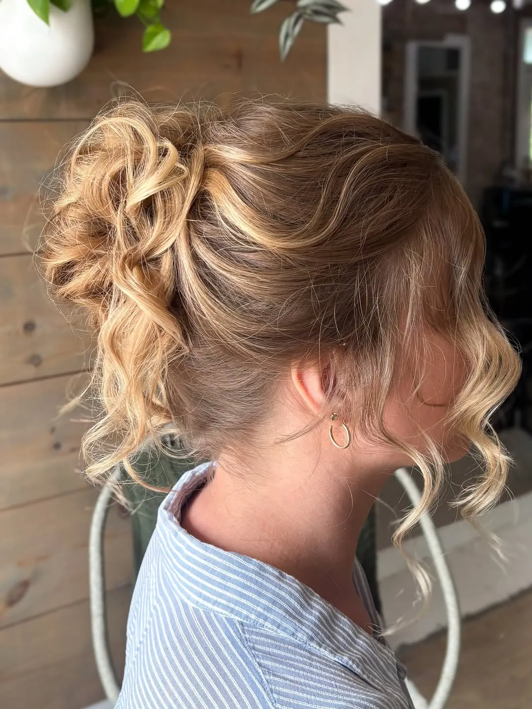 Loose curled bridal updo with face-framing pieces