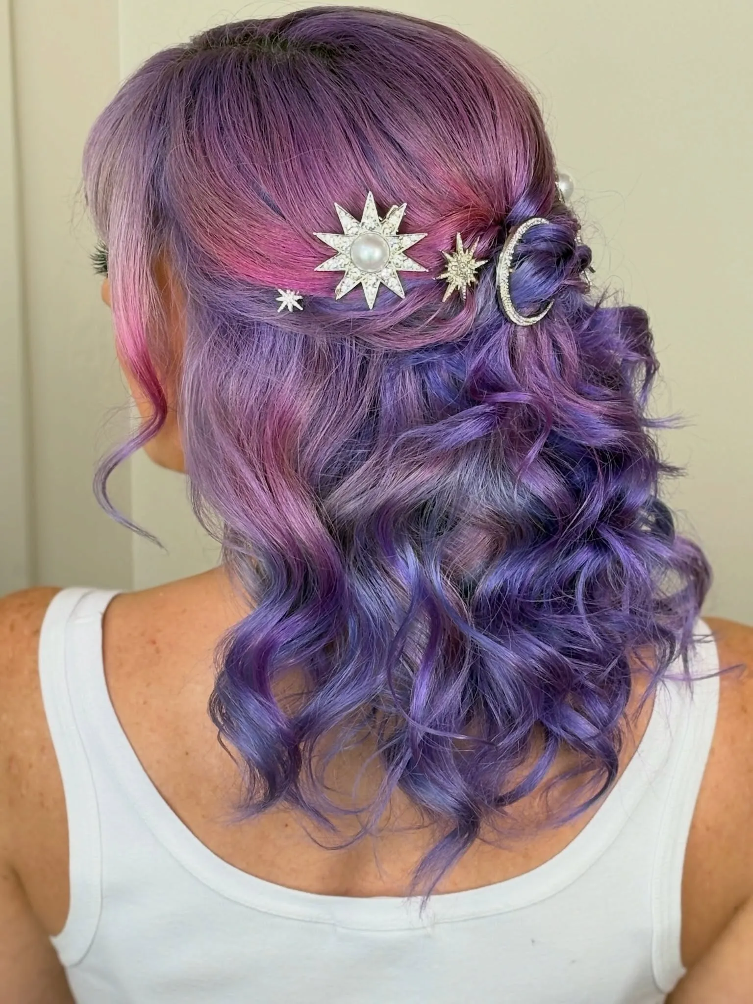 Half-up purple curls with moon and star hair pins