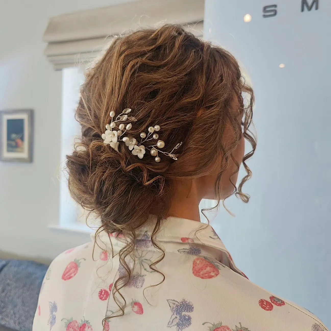 Soft low bridal bun with pearl branch hair pins