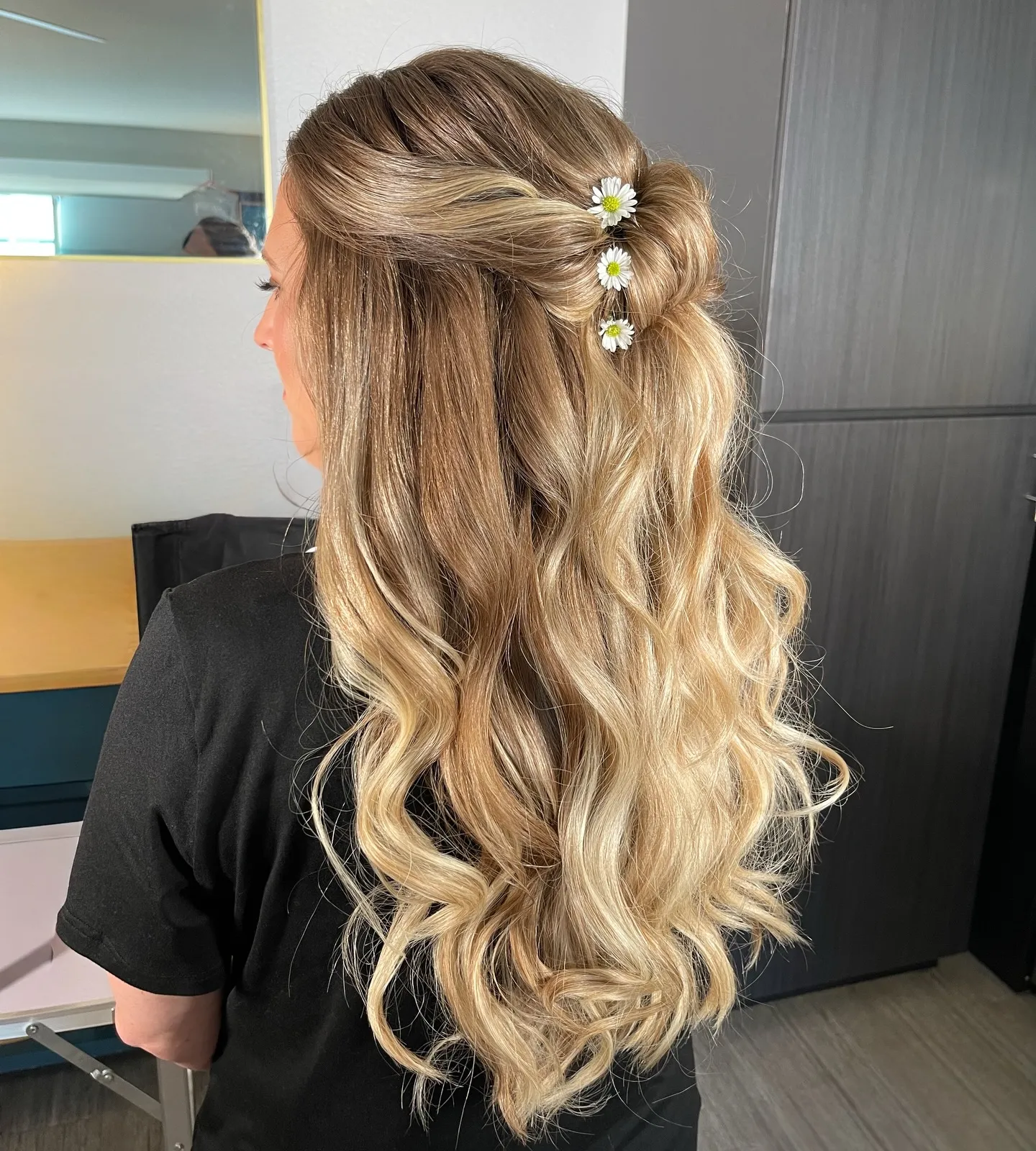 Long half-up bridal waves with small daisies