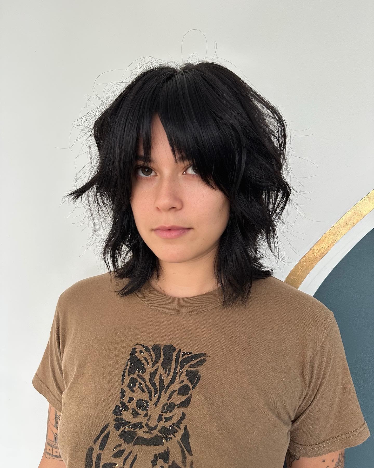 Short tousled wolf cut with curtain fringe and choppy ends