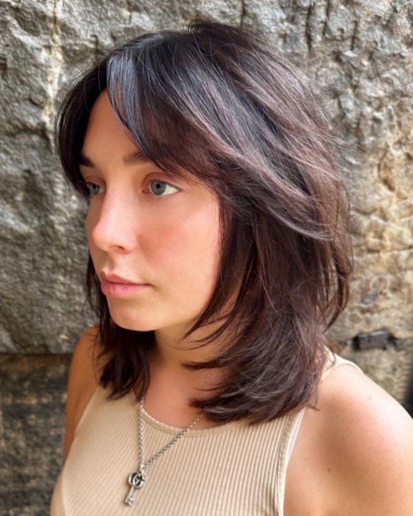 Smooth shoulder-length wolf cut with curtain layers and curved ends