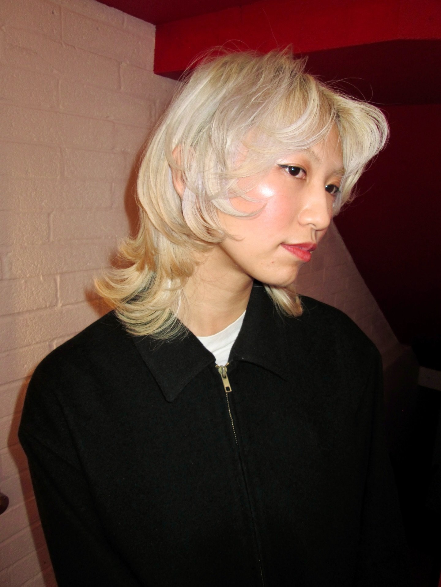 Platinum wolf cut with wispy fringe and flipped layered ends