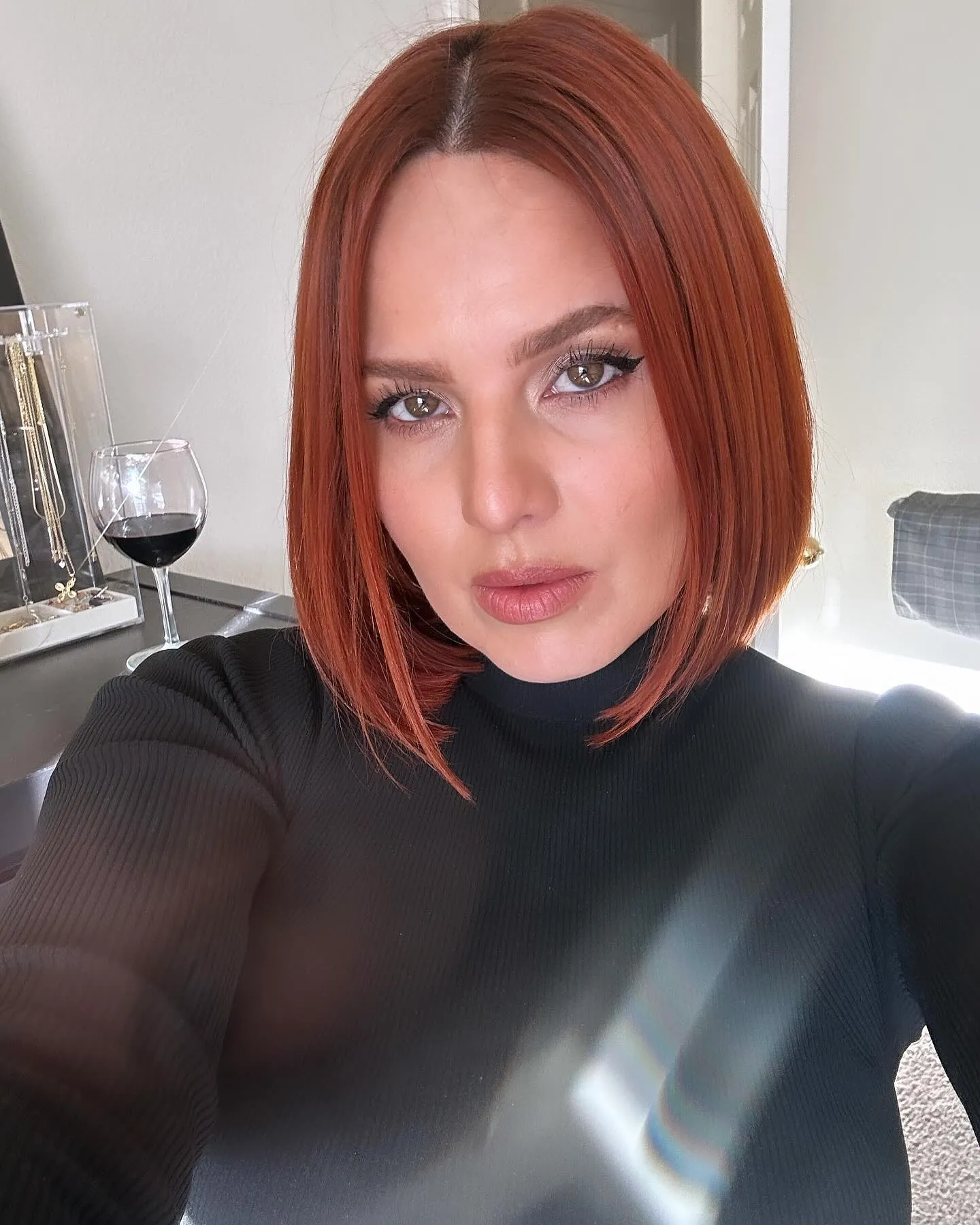 Center-parted sleek angled bob with straight ends