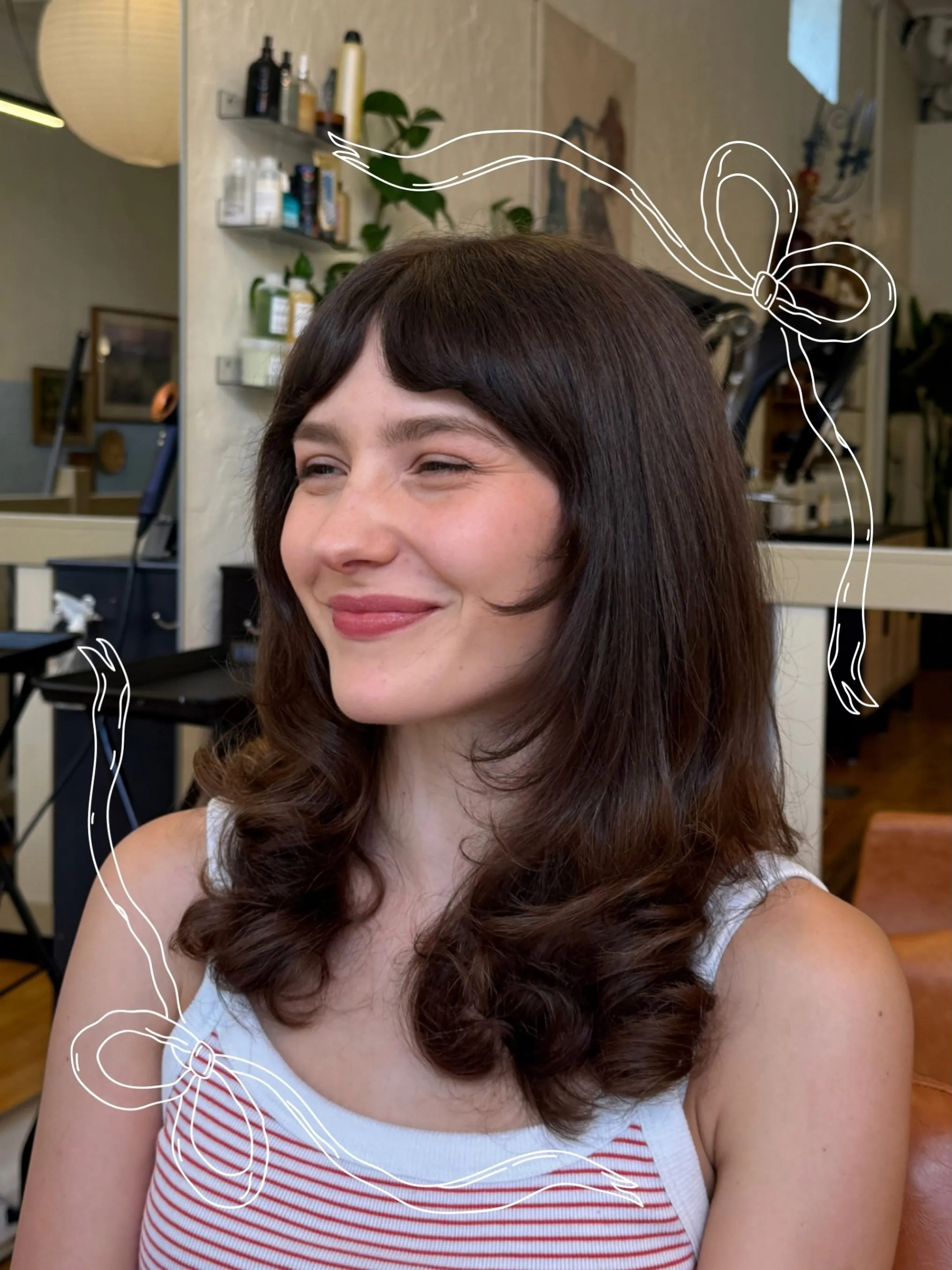 Dark shoulder-length haircut with full bangs and curled-out lower layers