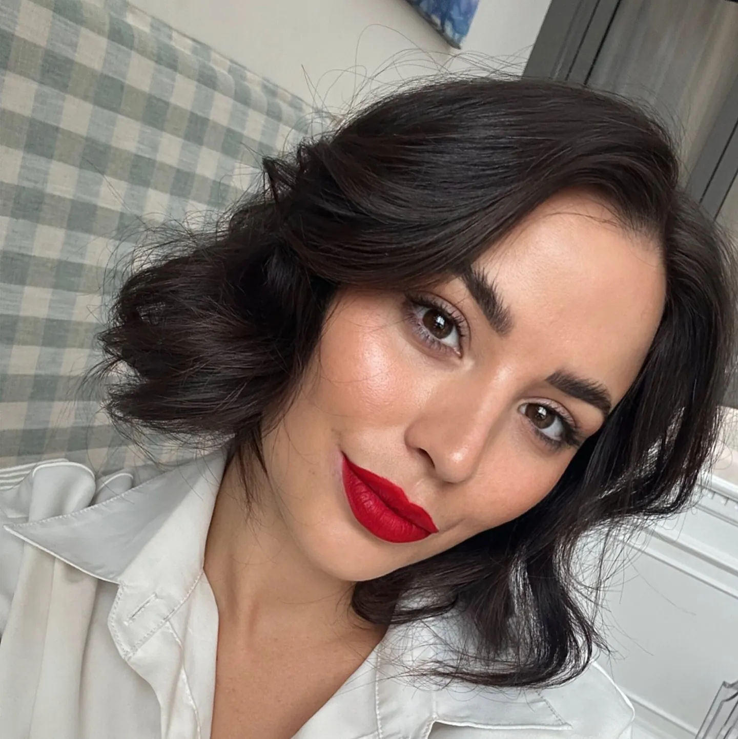 Dark layered haircut with side-swept fringe and flipped ends