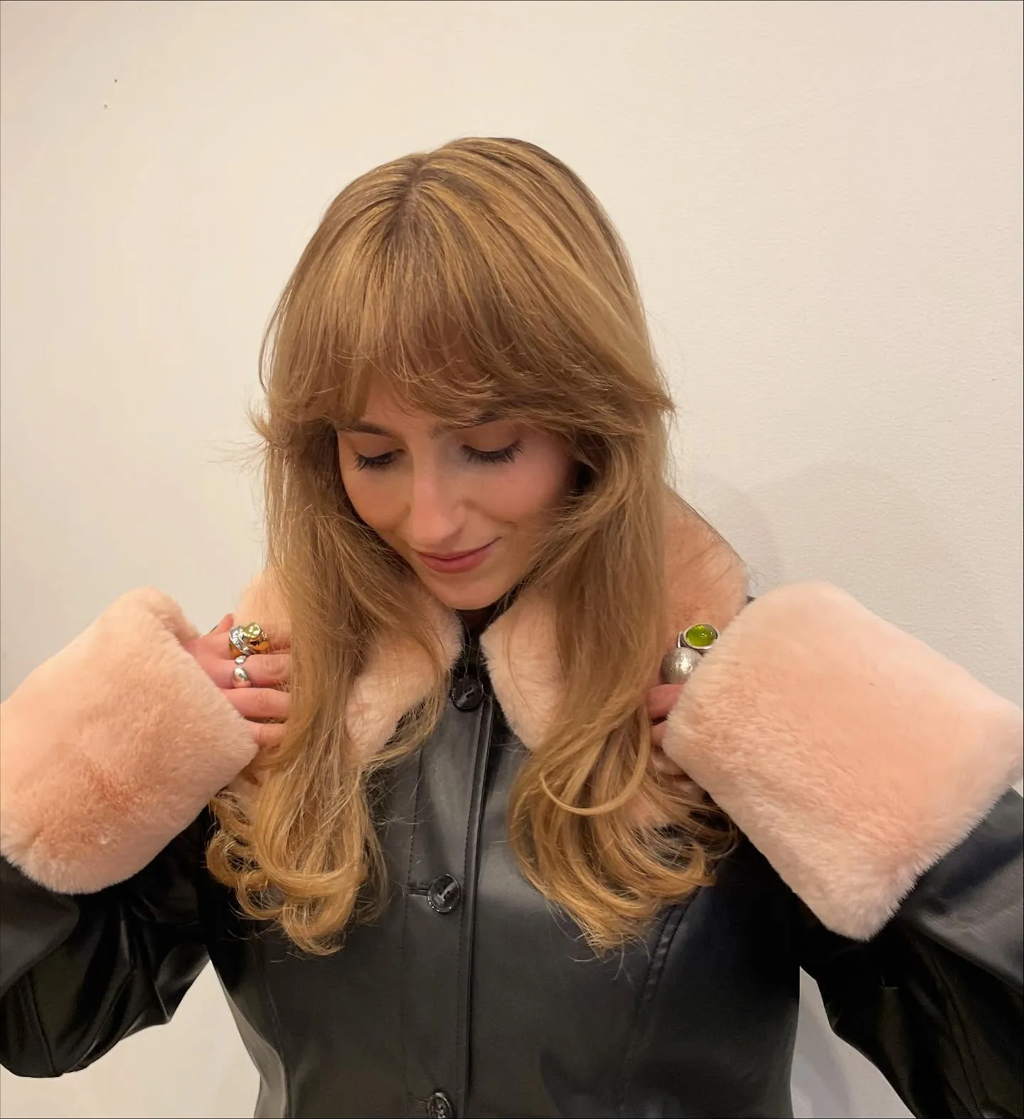 Feathered Birkin bangs with long blonde face-framing layers