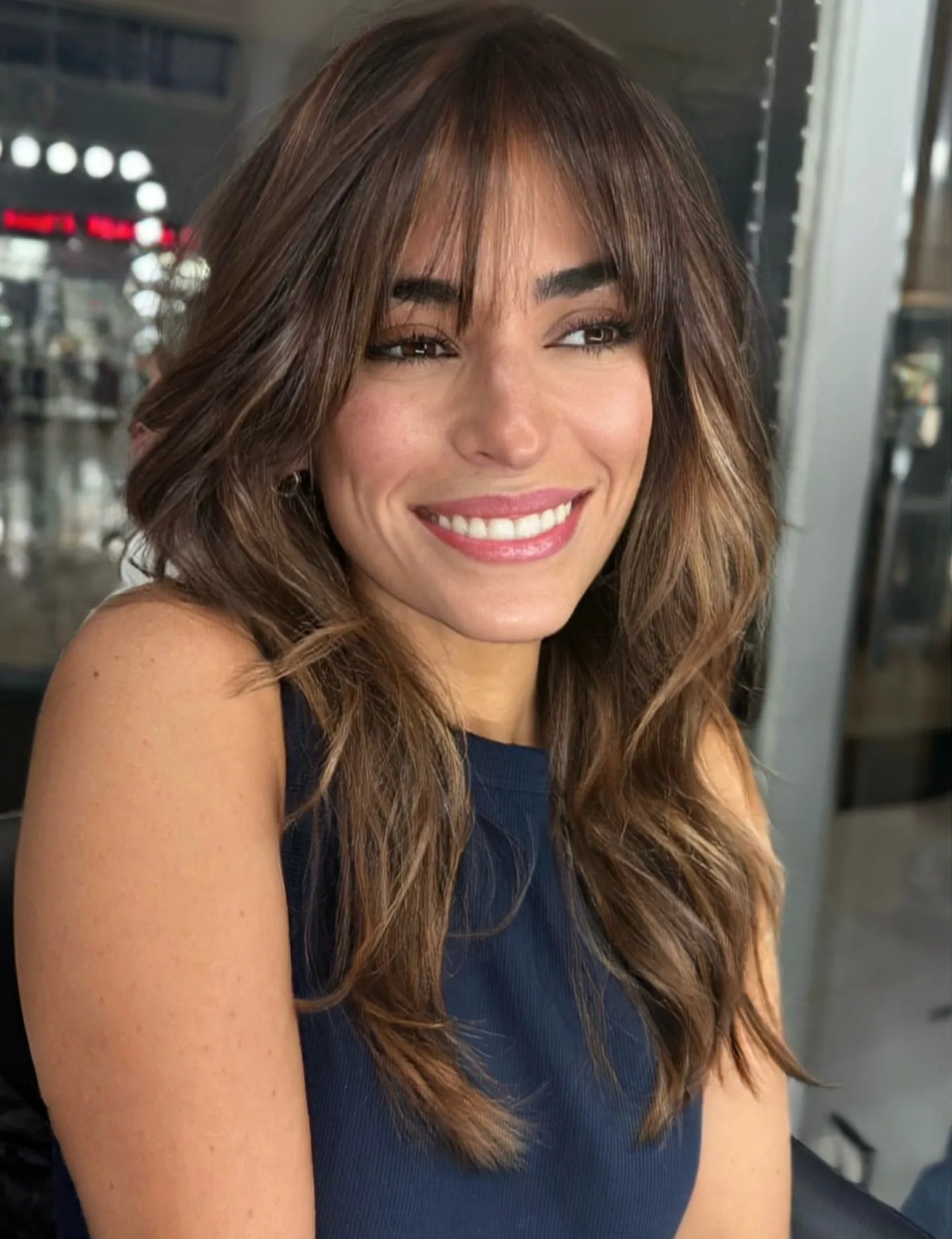 Tousled layered hair with airy Birkin bangs