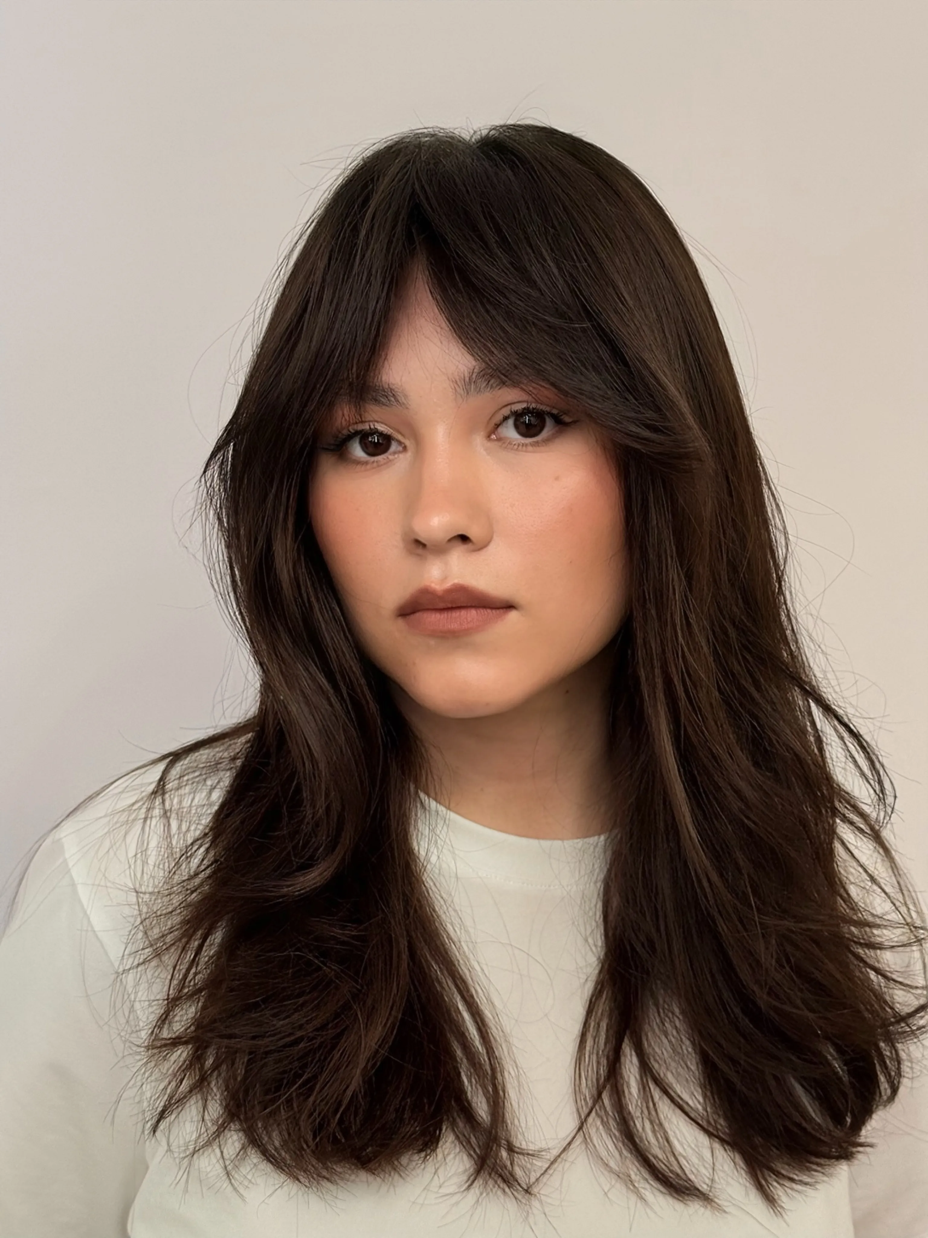 Long dark hair with narrow face-framing fringe