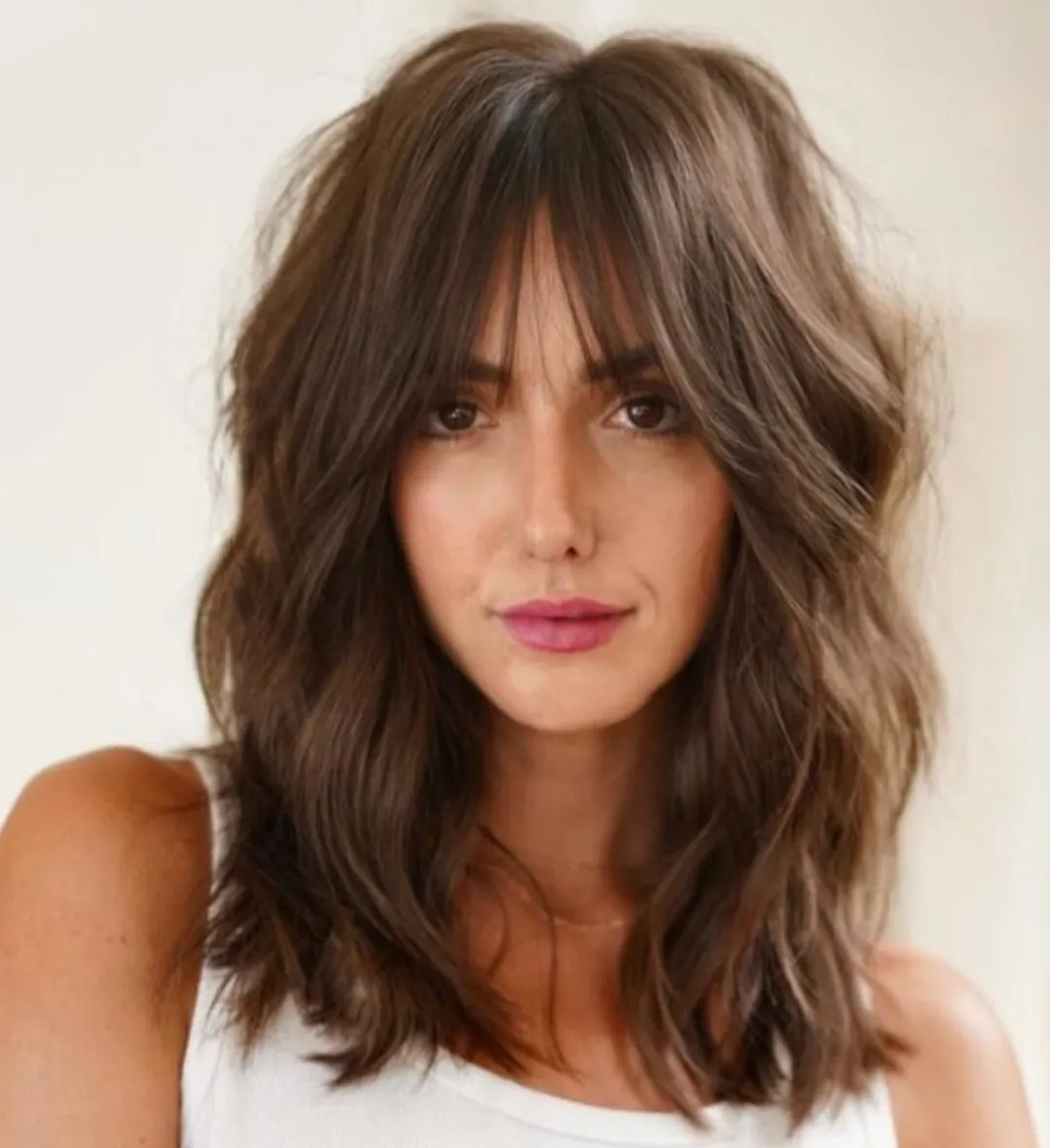 Shaggy shoulder-length haircut with piecey Birkin fringe