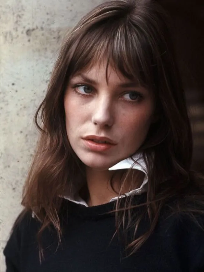 Straight dark hair with classic brow-skimming Birkin bangs