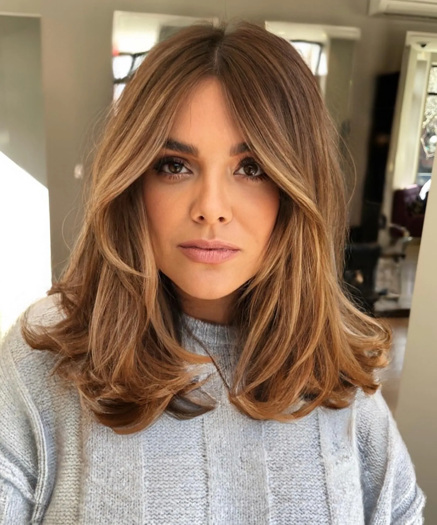 Shoulder-length blowout with center-split fringe