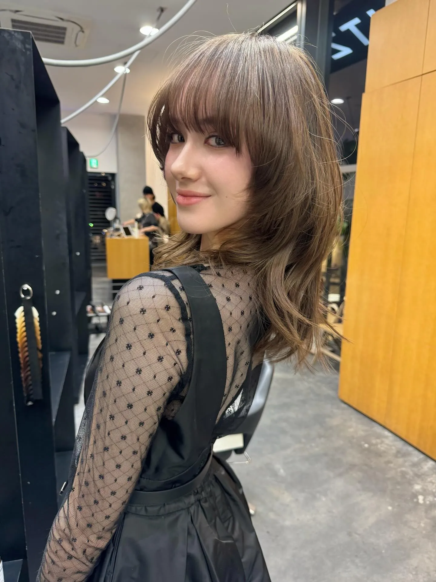 Layered medium hair with rounded Birkin bangs