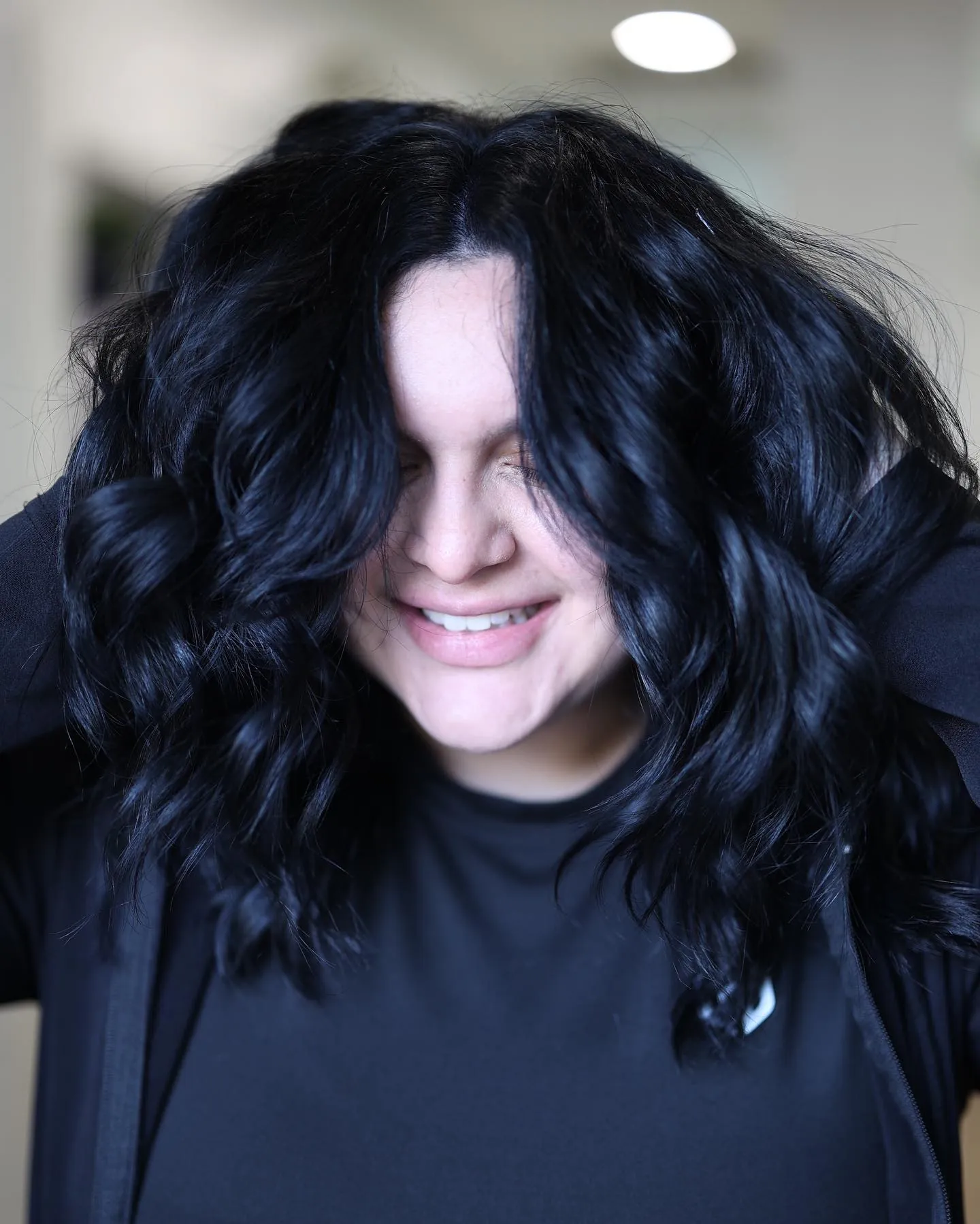 Blue-Black Curly Bob showing blue black hair colour