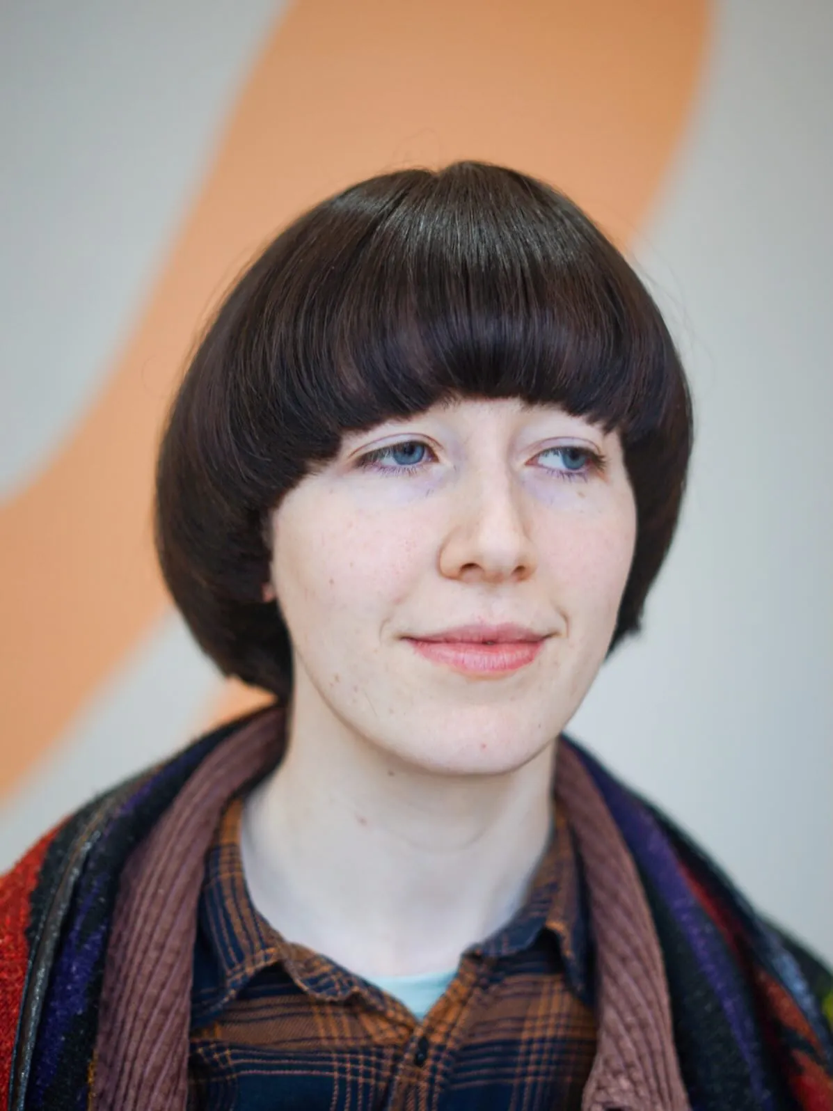 Full dark rounded bowl cut with ear length sides