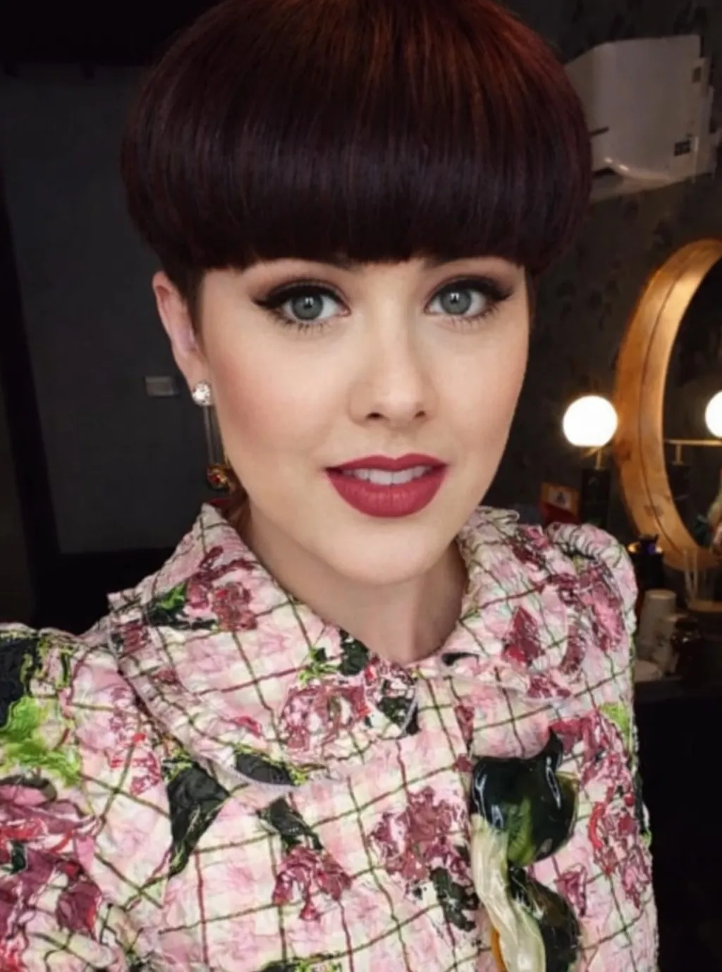 Deep brunette bowl cut with full rounded fringe
