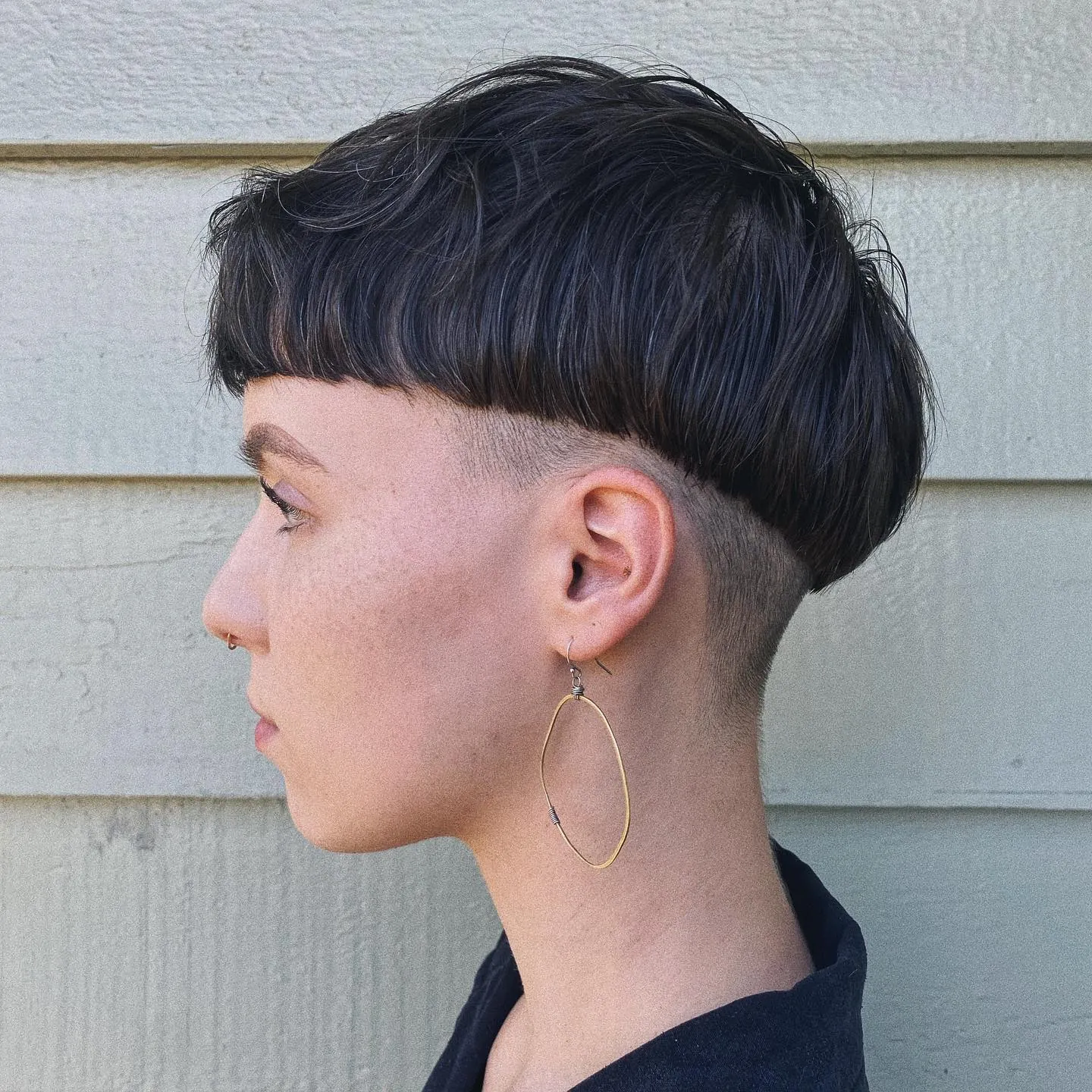 Dark bowl cut with shaved undercut sides