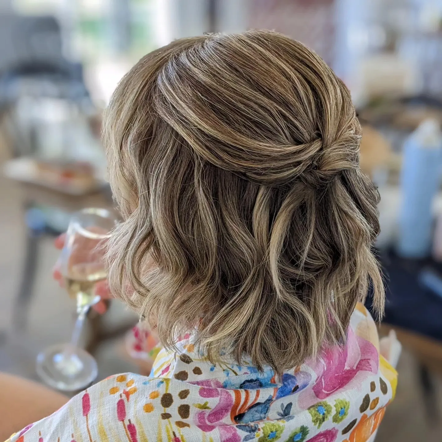 Blonde wavy bob with a twisted half-up back