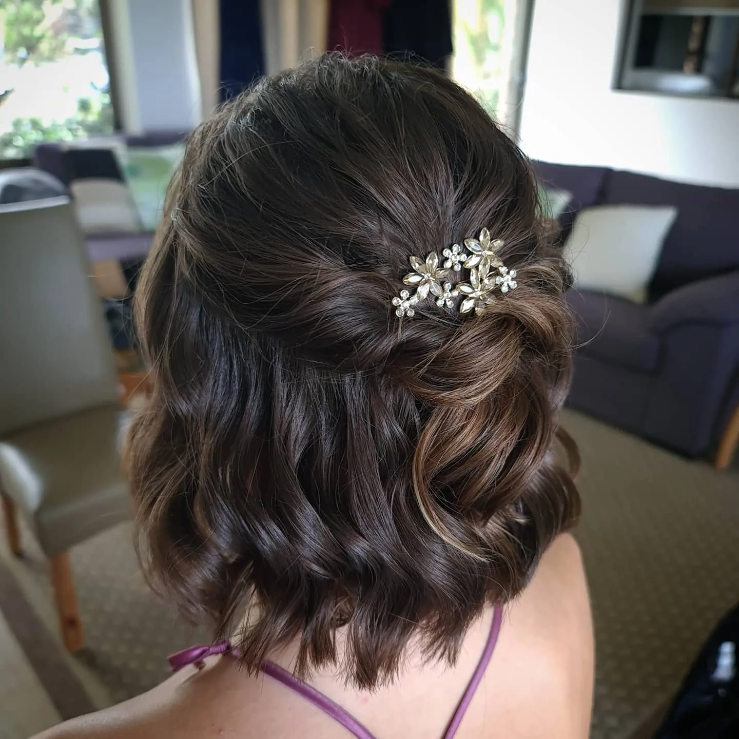 Dark wavy bob with a jeweled half-up twist