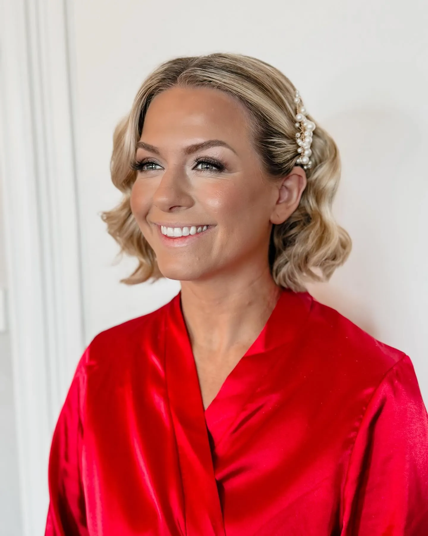 Short blonde bob with vintage waves and jeweled clips