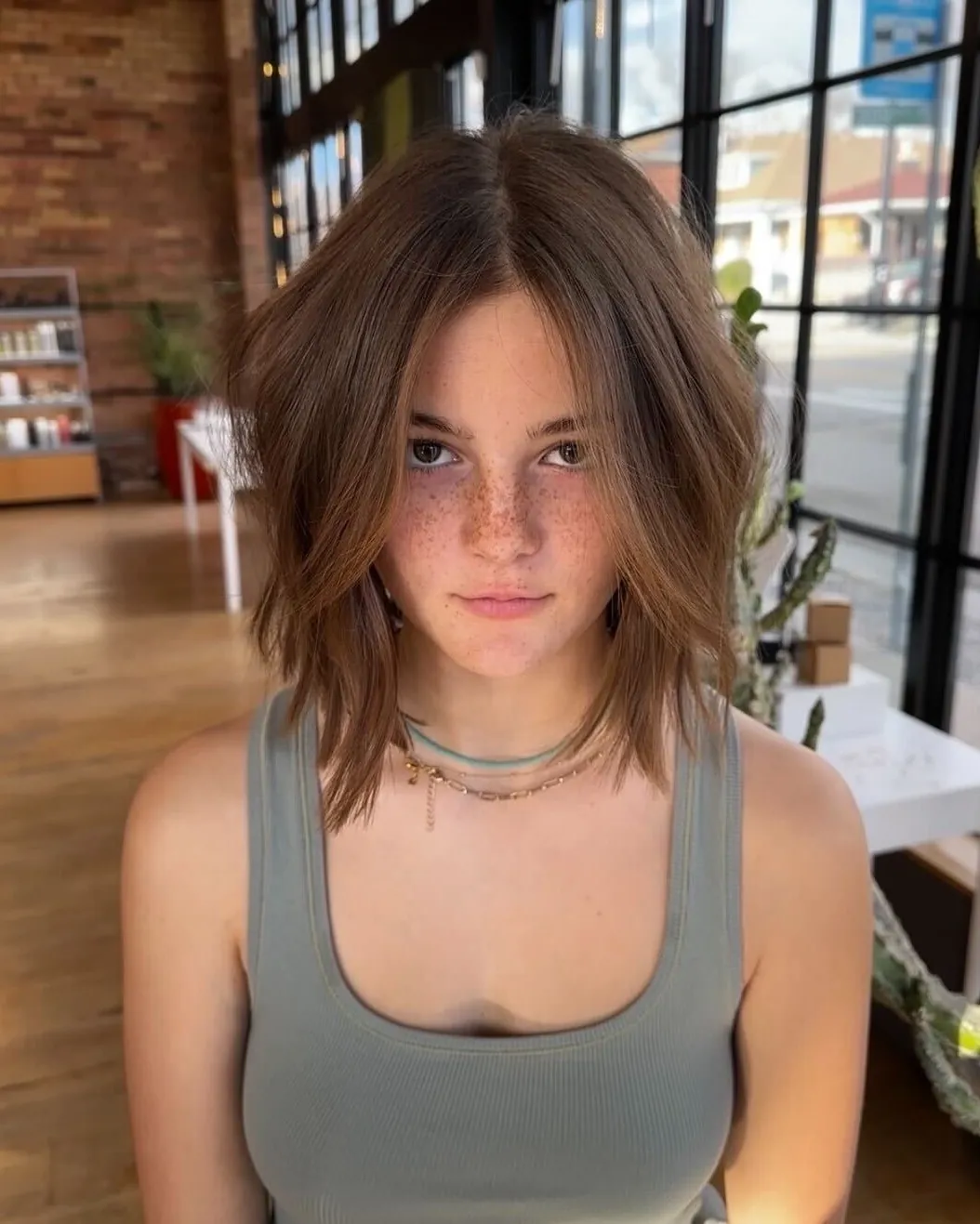 Tousled brown bubble bob with center part and soft volume