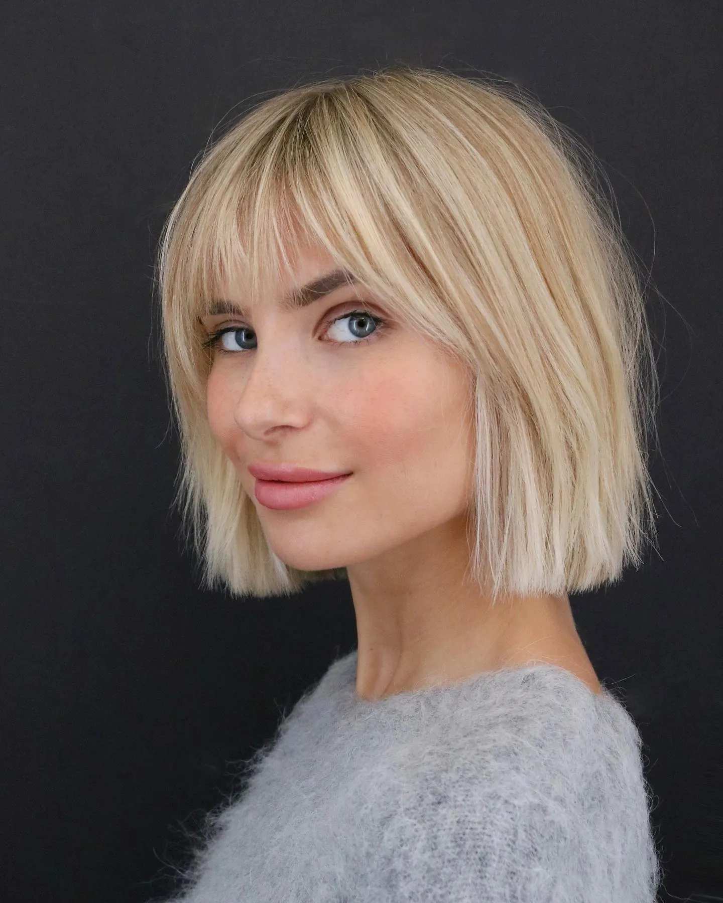 Blonde bubble bob with full fringe and straight rounded ends