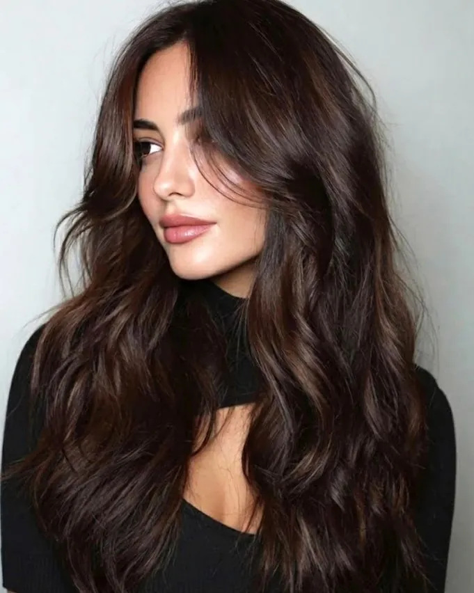 Long smoky charcoal brunette hair with butterfly layers and curtain pieces