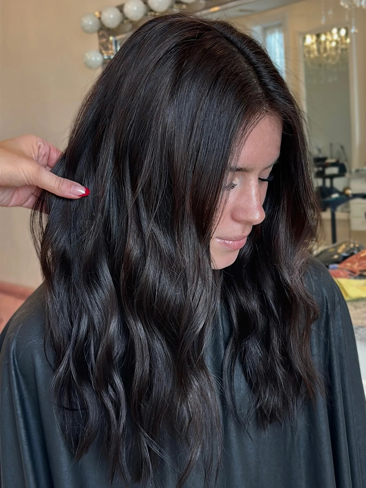 Inky charcoal brunette hair with soft waves and subtle cool dimension