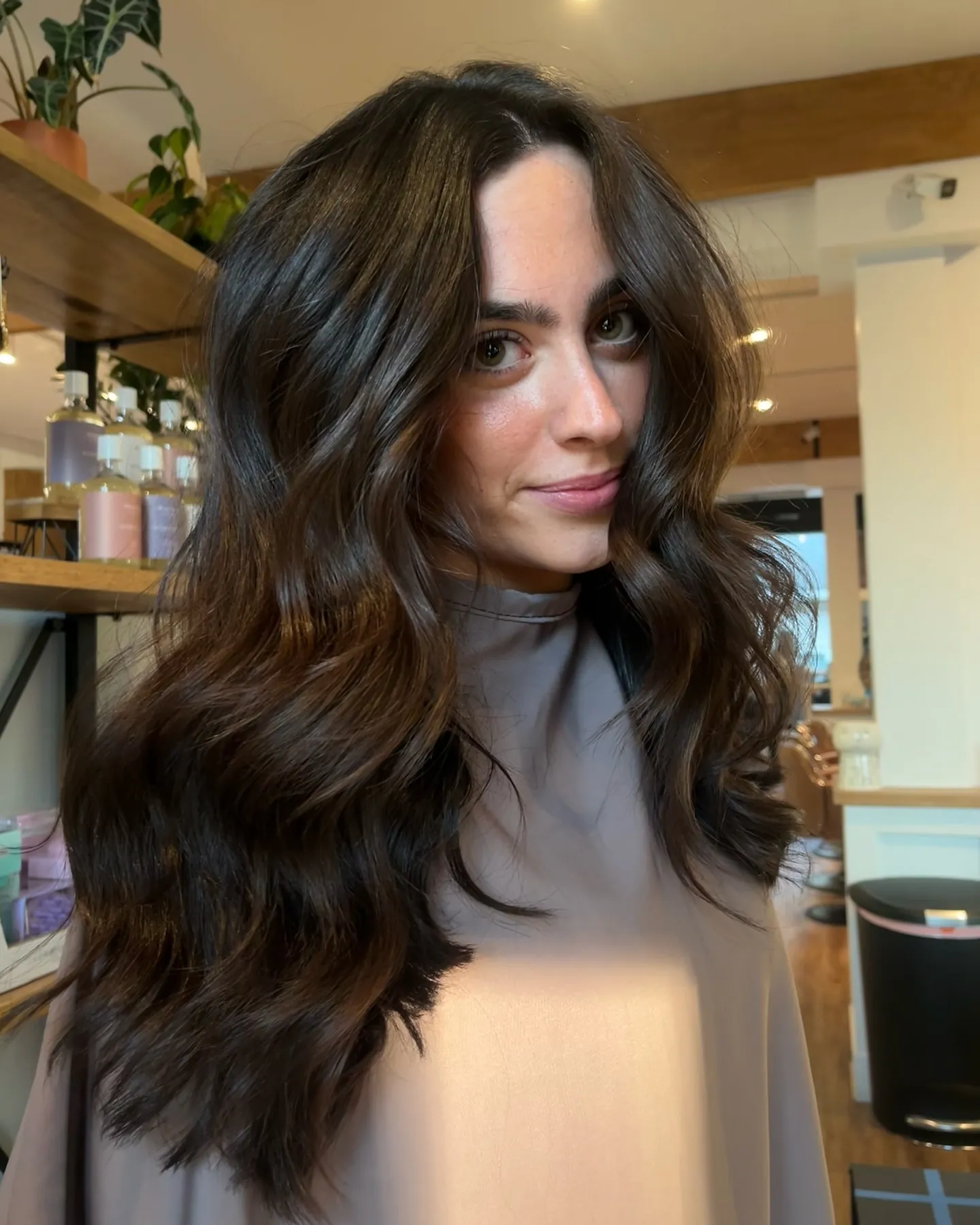 Cool espresso brunette hair with soft waves and center part