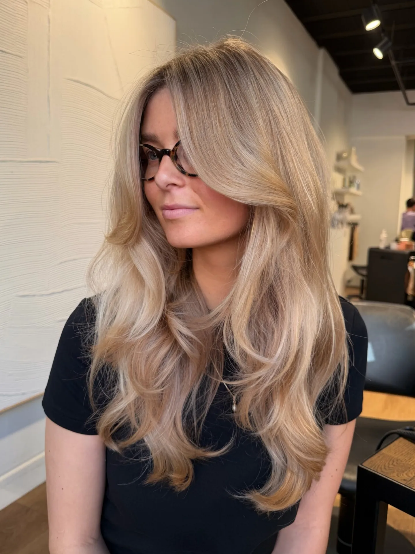 Pale neutral blonde layers with darker root shadow