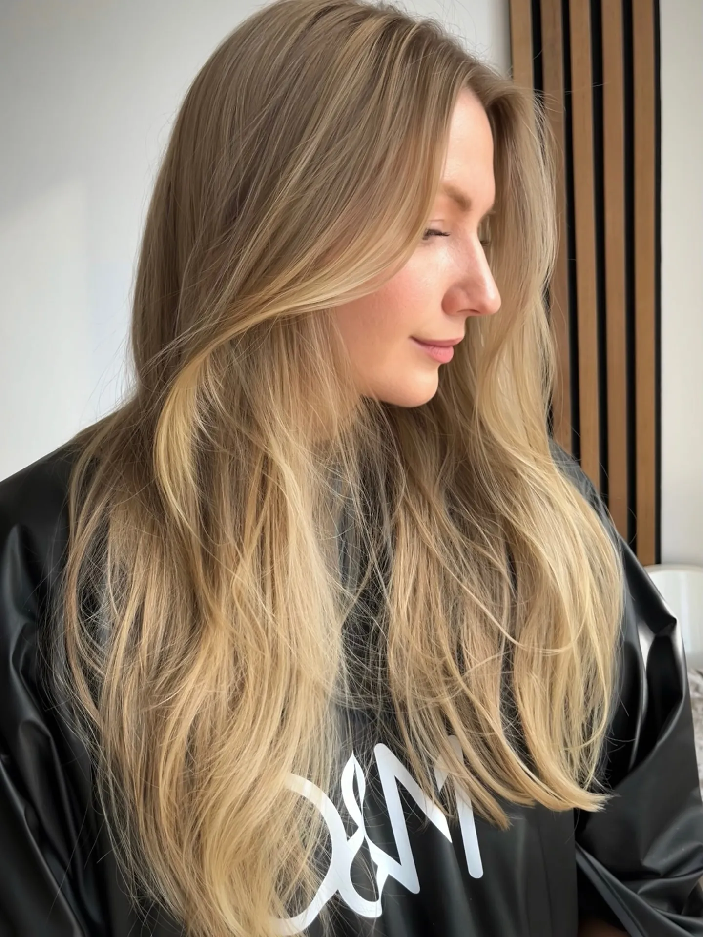 Long beige blonde layers with soft brunette root