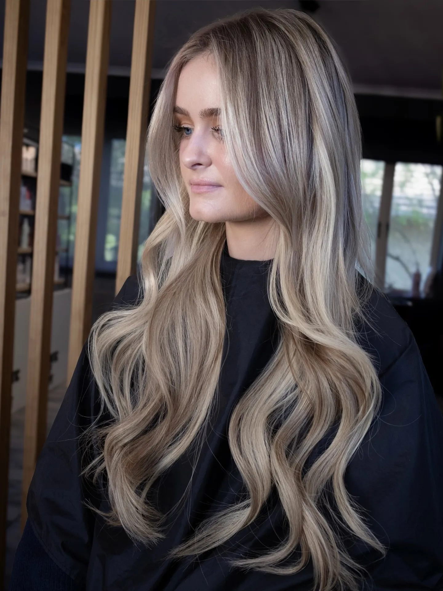Long cool neutral blonde waves with shadow root