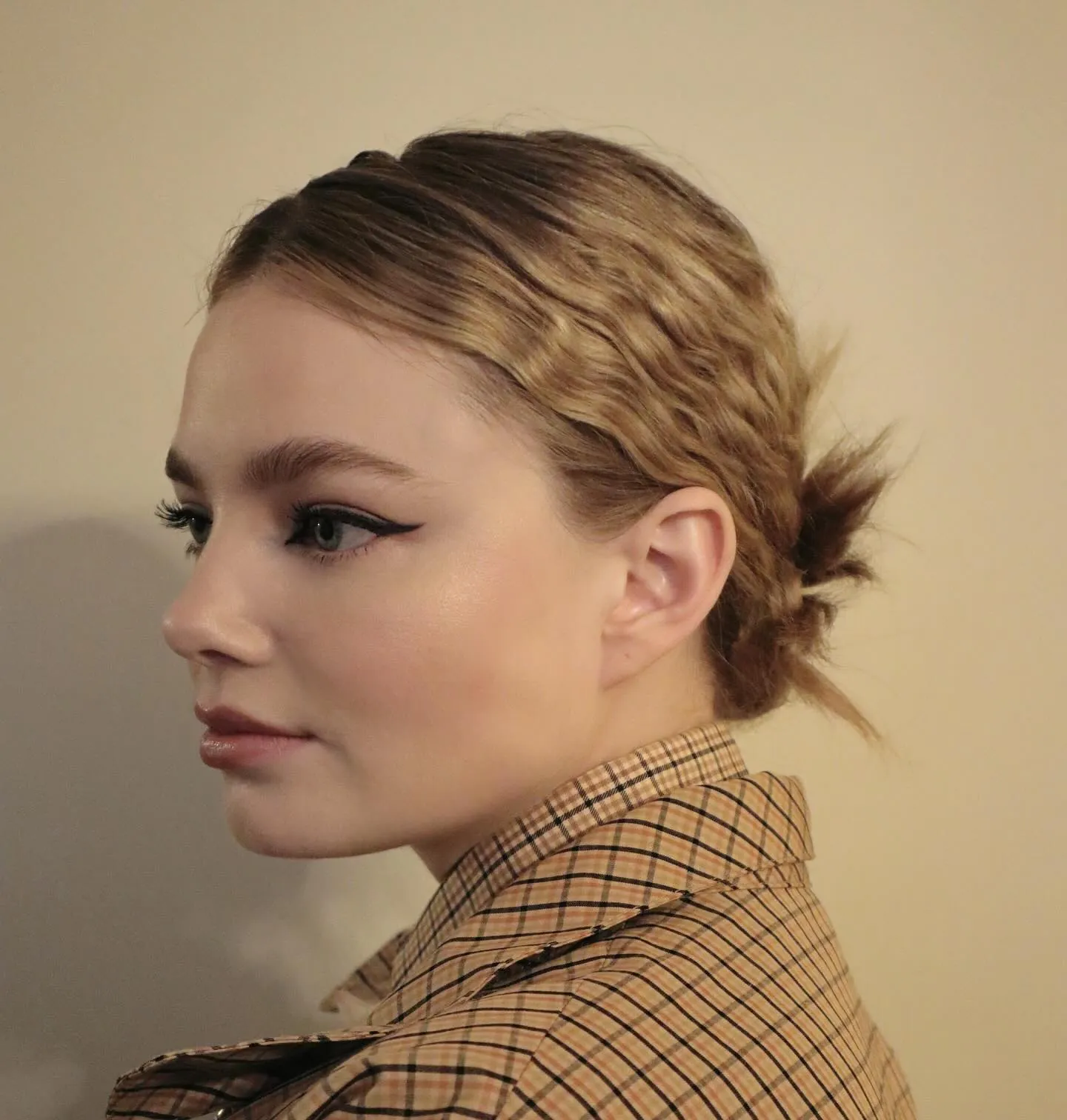 Slick low bun with crimped side texture