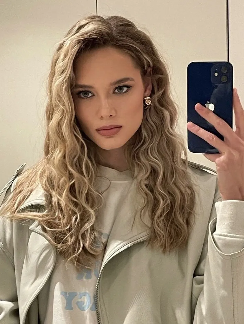 Medium blonde hair with loose crimped curls