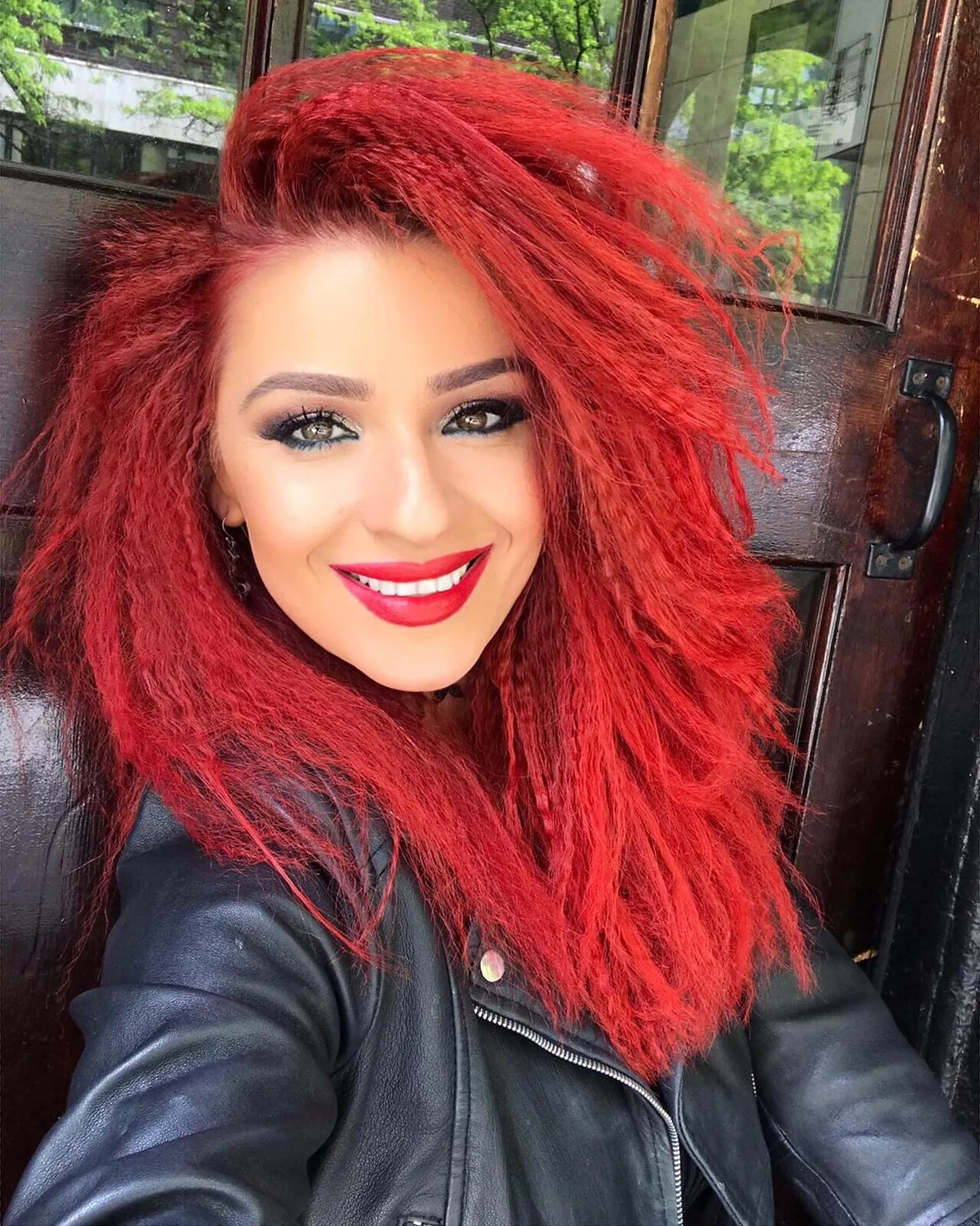 Bright red hair with brushed crimped volume