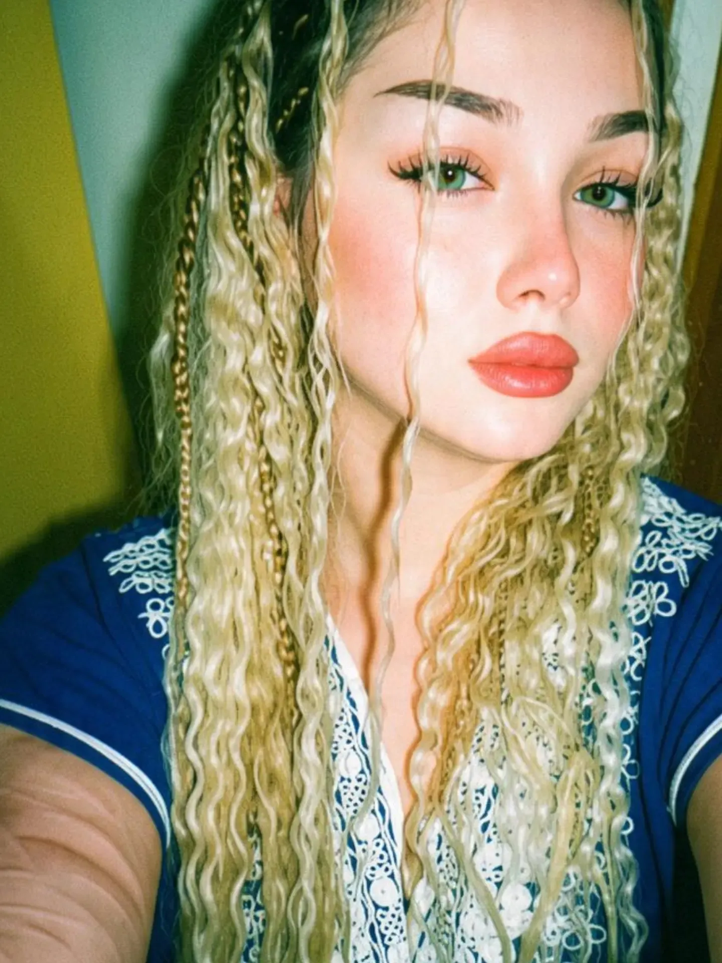 Long blonde hair with crimped face framing strands